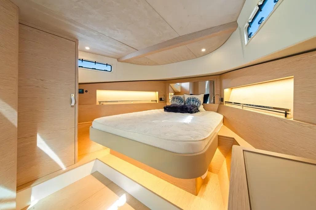 Luxurious interior of 2024 Solaris Power 44 Open yacht with modern design and cozy bedroom.