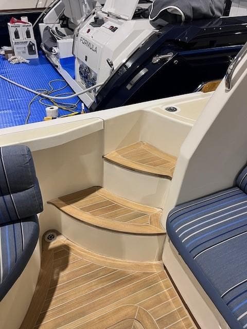 2011 Sabre 40 Sedan interior with wooden steps and blue seating.