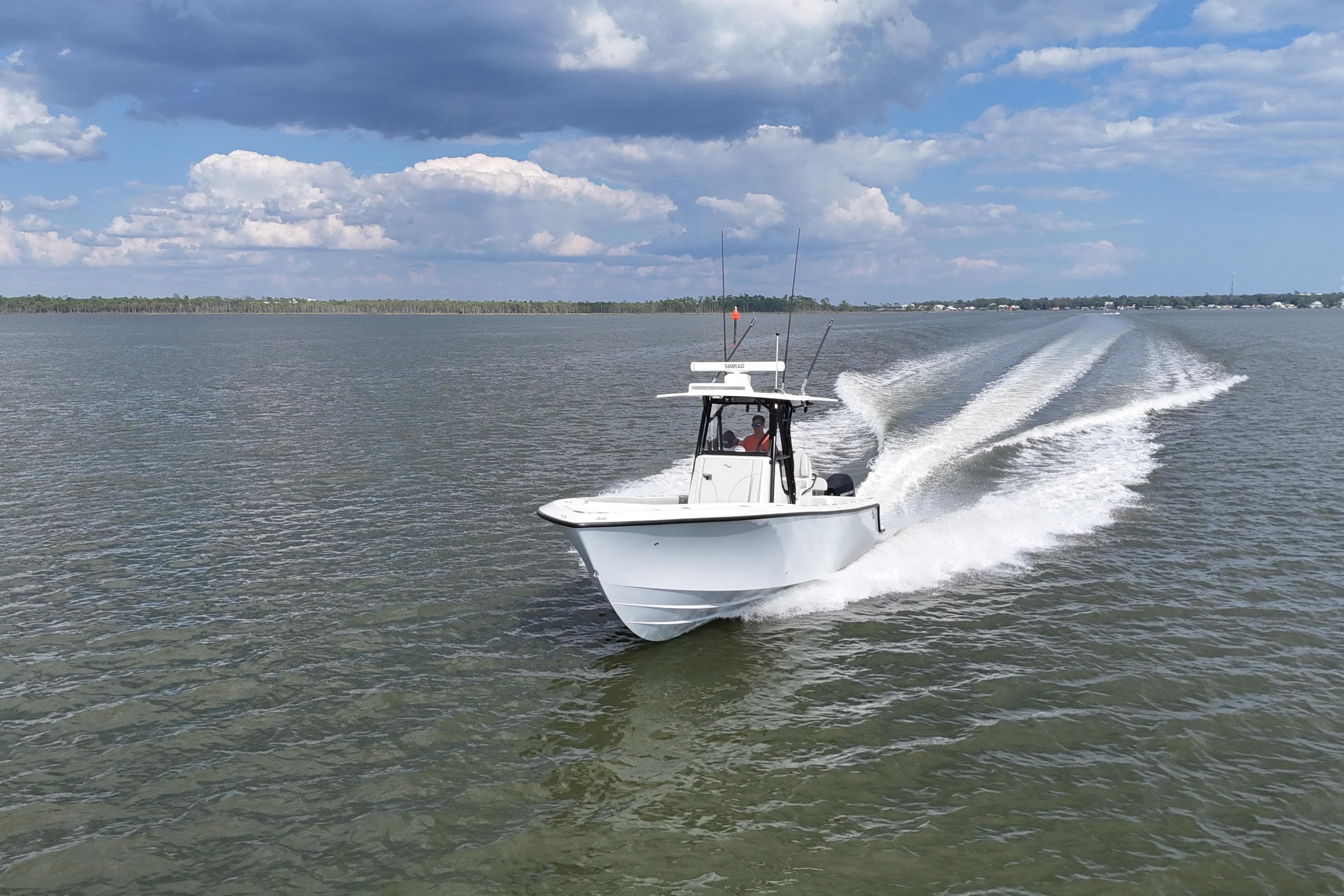 2023 SeaVee 32 boat cruising on open water under a partly cloudy sky.