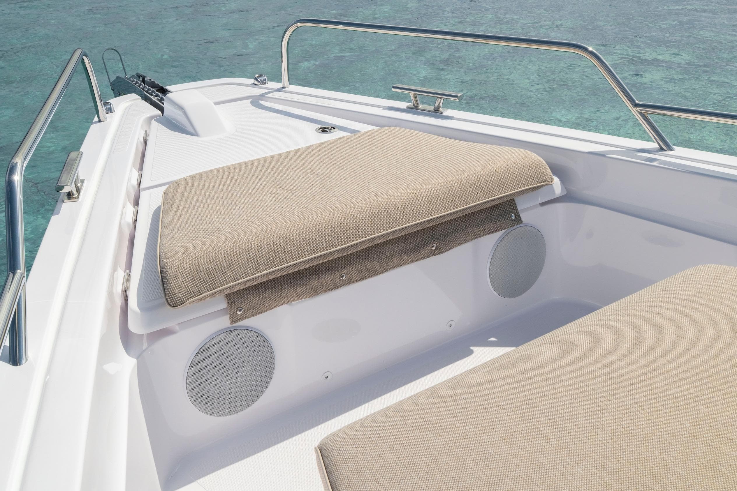 2025 Axopar 45 Cross Top boat with beige seating and stainless steel railings.