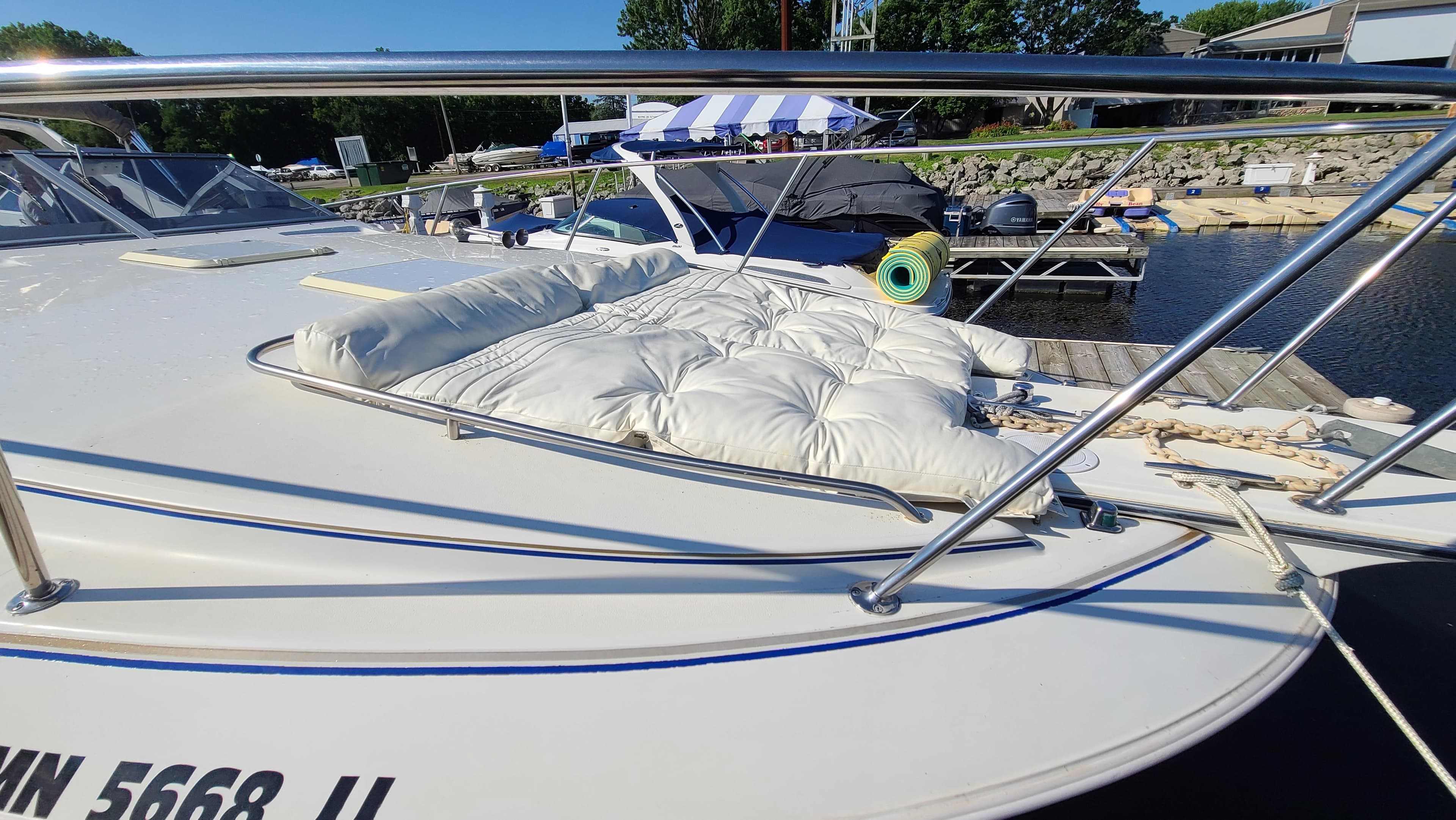 1994 Larson 300 Cabrio boat docked with cushioned deck area.