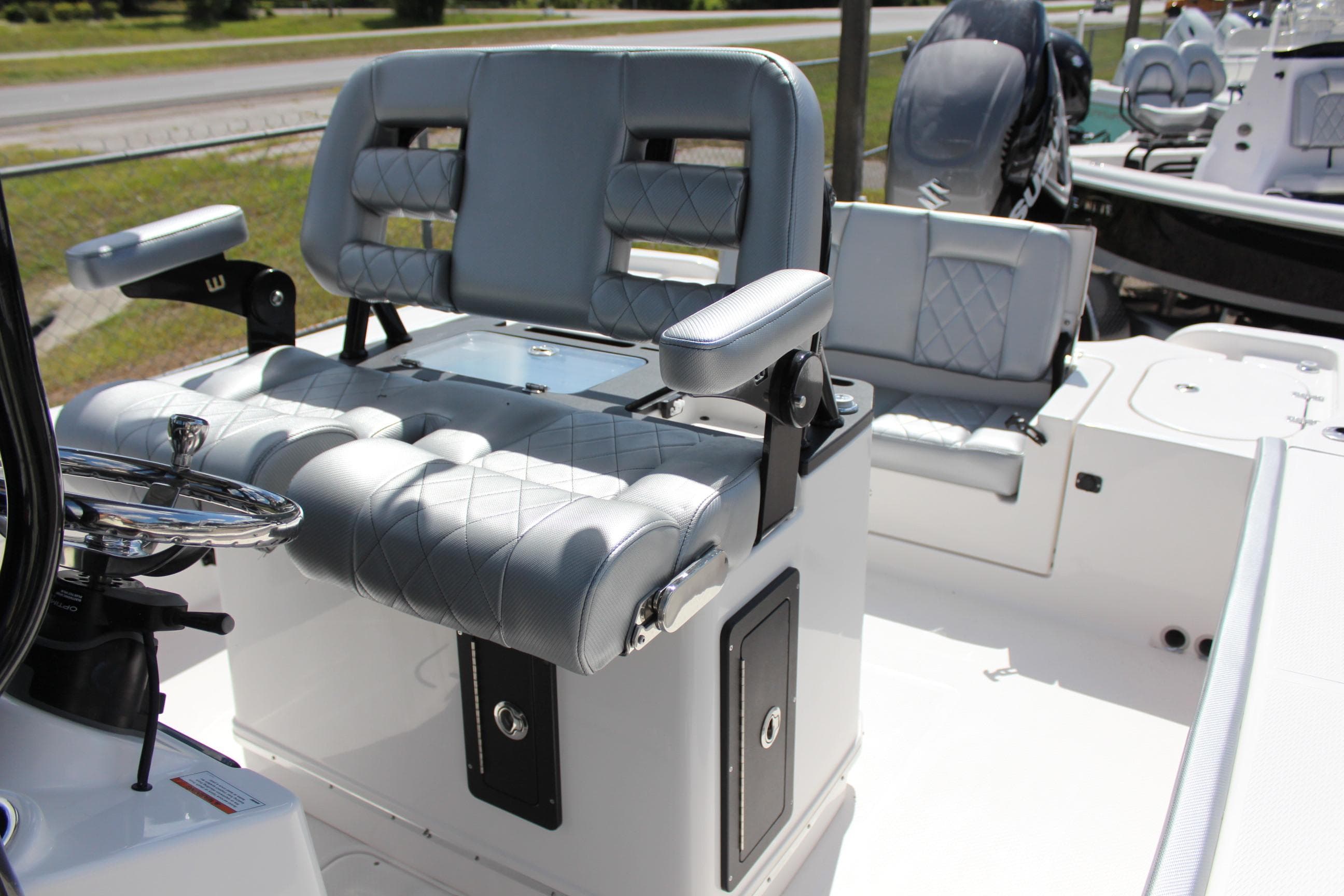 2023 Blue Wave 2600 Makaira boat with cushioned seating and steering console.