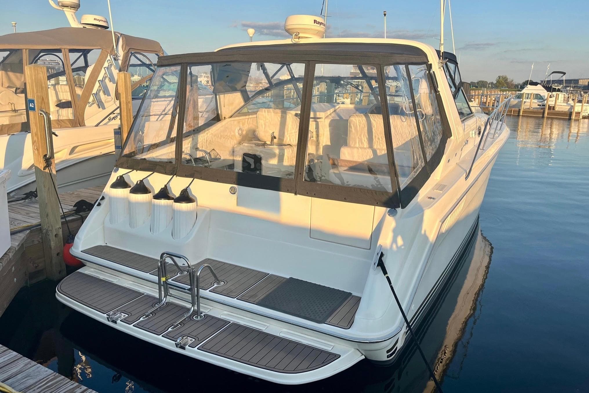 1994 Sea Ray 370 Express Cruiser docked at marina, rear view.
