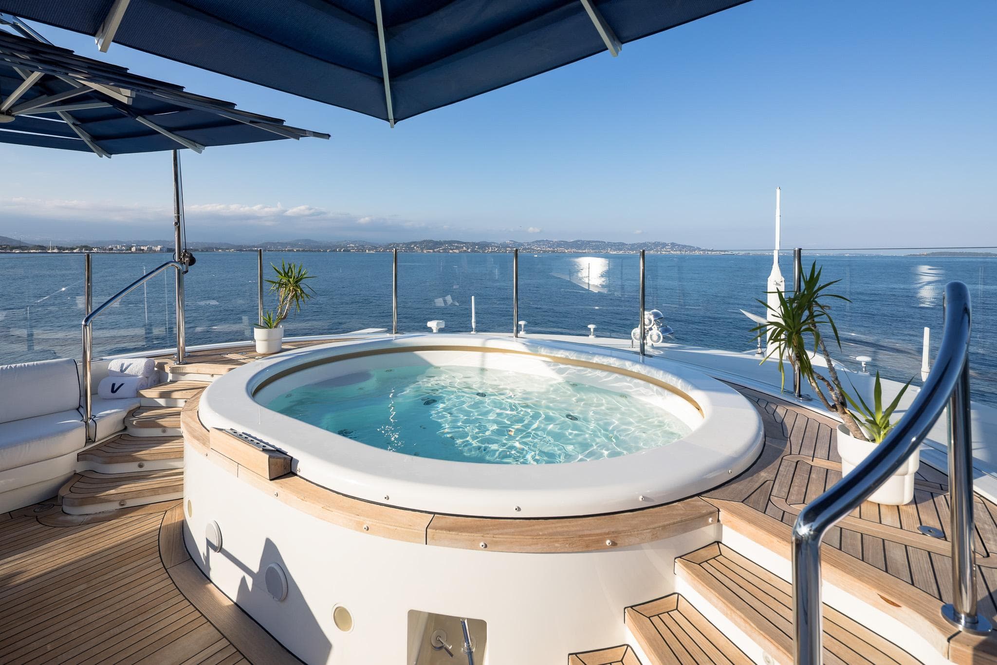Luxurious Benetti 60 yacht deck with jacuzzi, ocean view, and elegant seating, 2011 model.