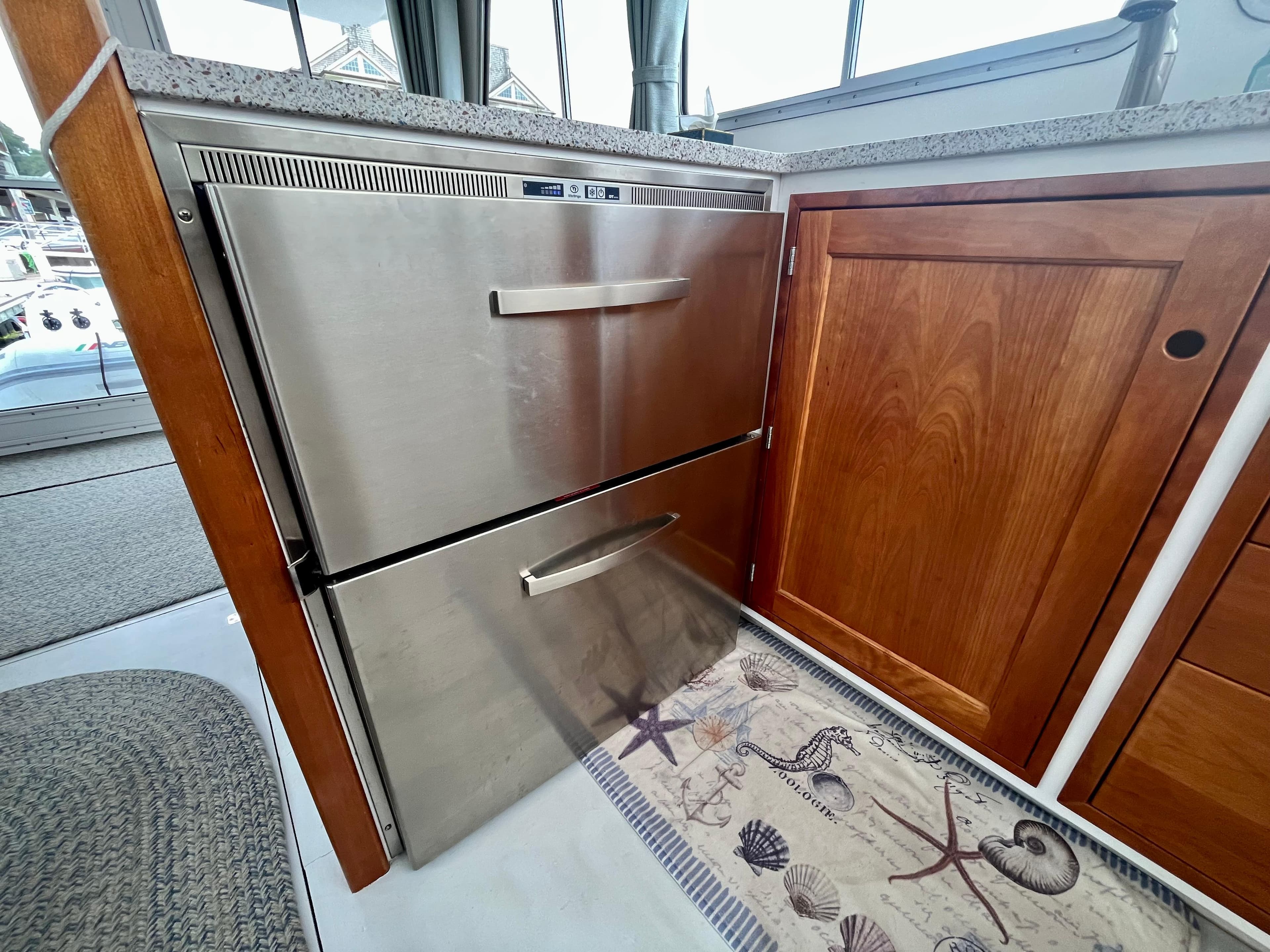 Stainless steel drawers in 2016 Wesmac 42 boat interior, next to wooden cabinetry.