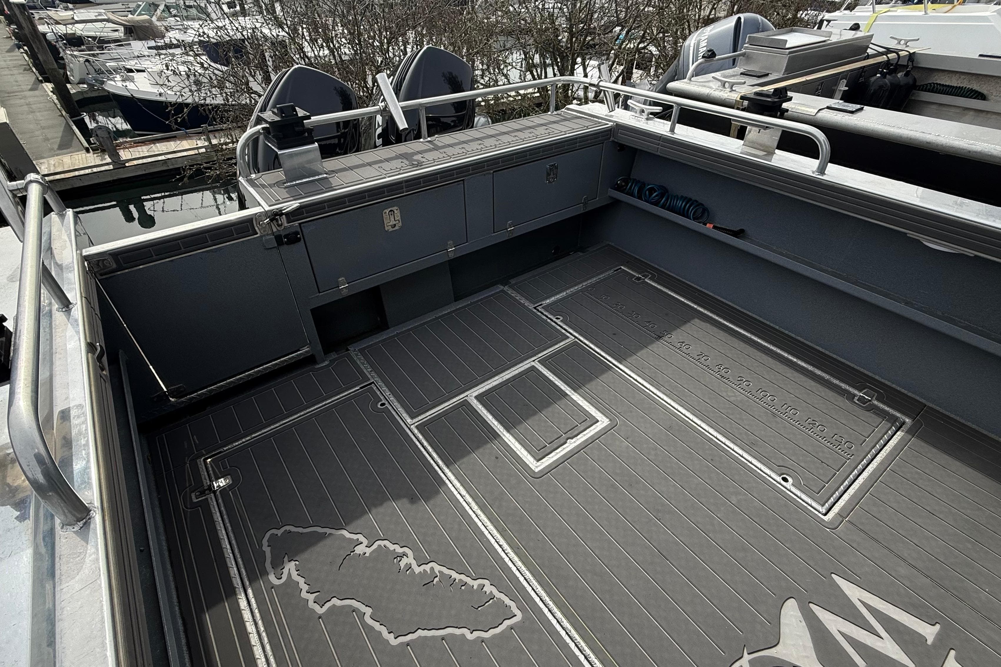 Spacious deck of a 2021 Northwest 28 boat with storage compartments.