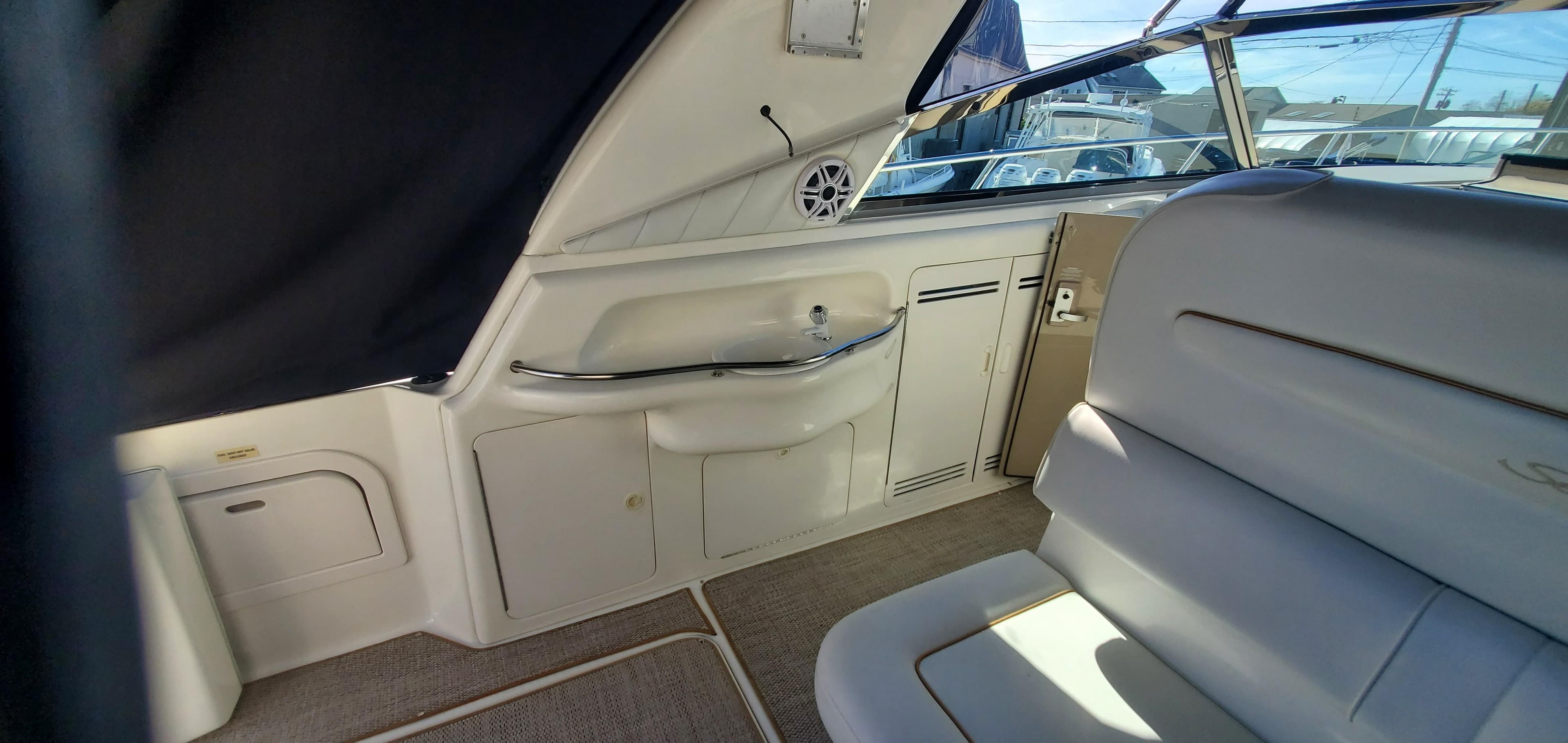 Interior of a 1998 Sea Ray 400 Sundancer yacht with seating and storage compartments.