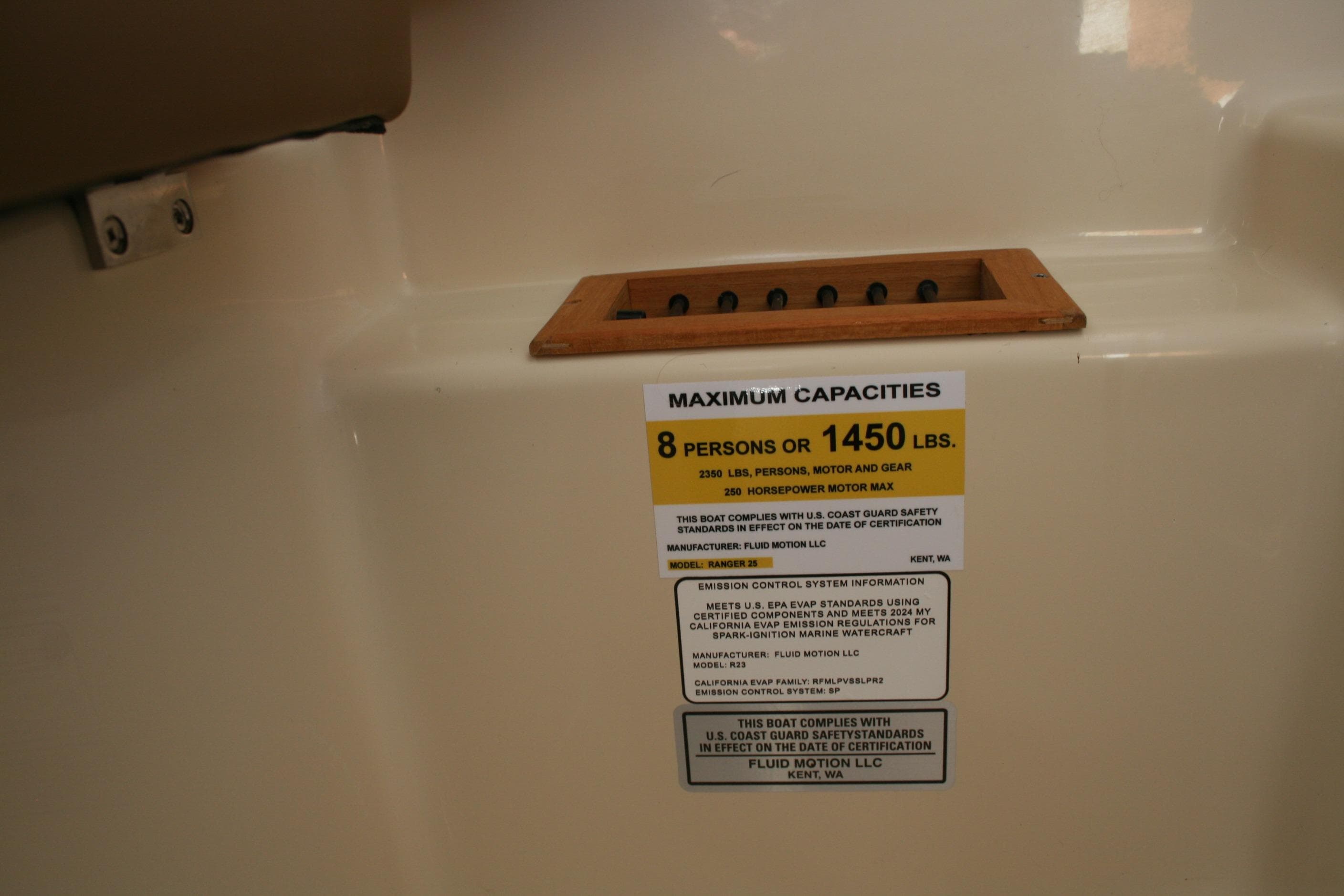 2024 Ranger Tugs R-25 capacity label, maximum 8 persons or 1450 lbs, 250 horsepower motor.