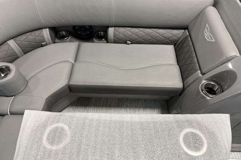 Luxurious seating on 2025 Bennington 22 LSRSE boat with quilted upholstery and cup holders.