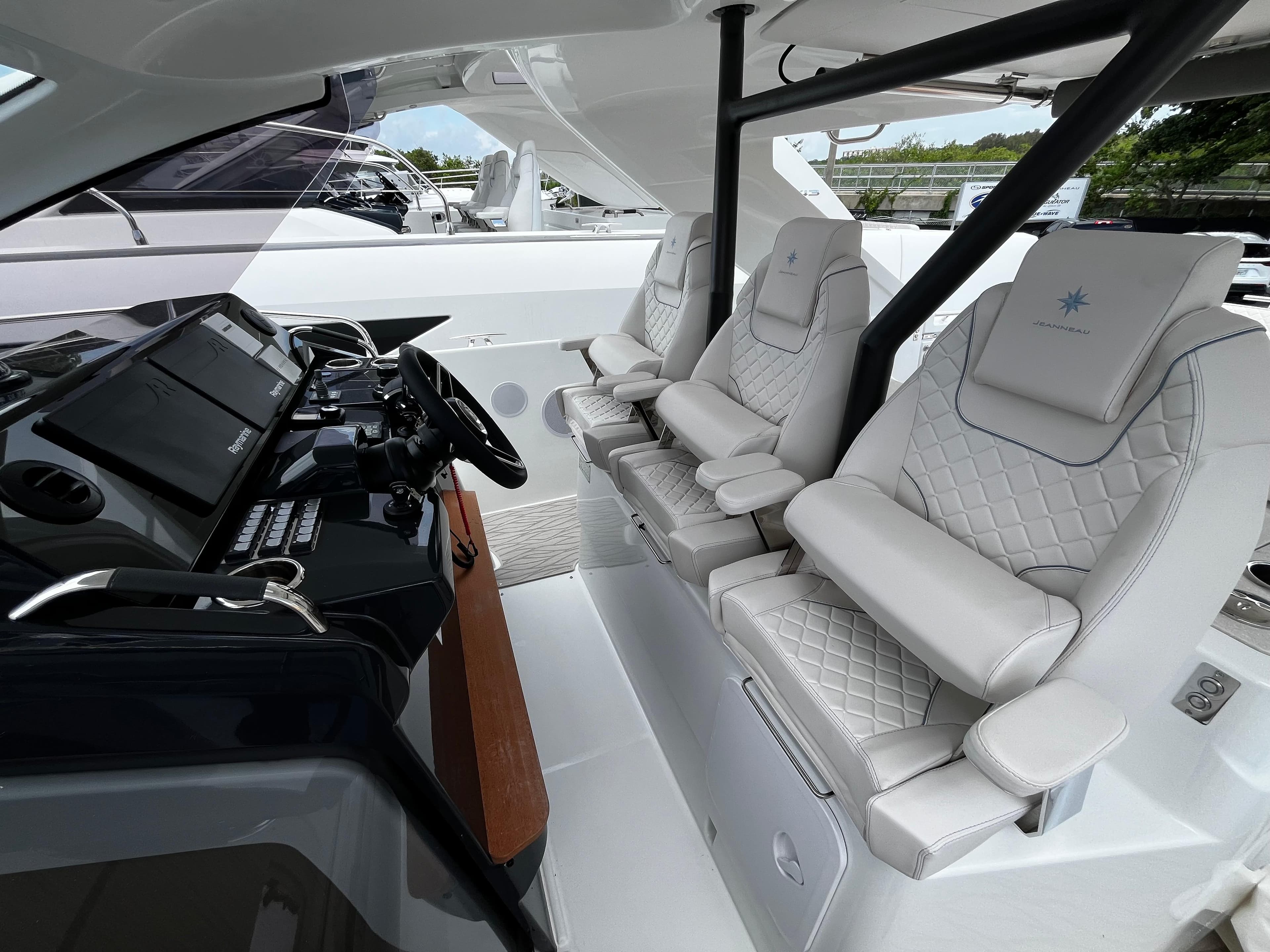 2024 Jeanneau DB37 cockpit with luxurious white seating and modern control panel.
