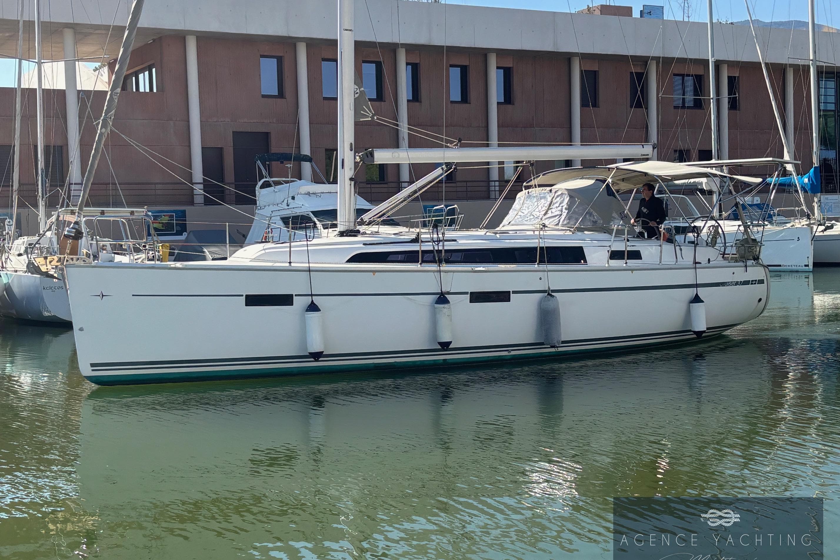 2014 Bavaria Cruiser 37 yacht docked in marina, side view.