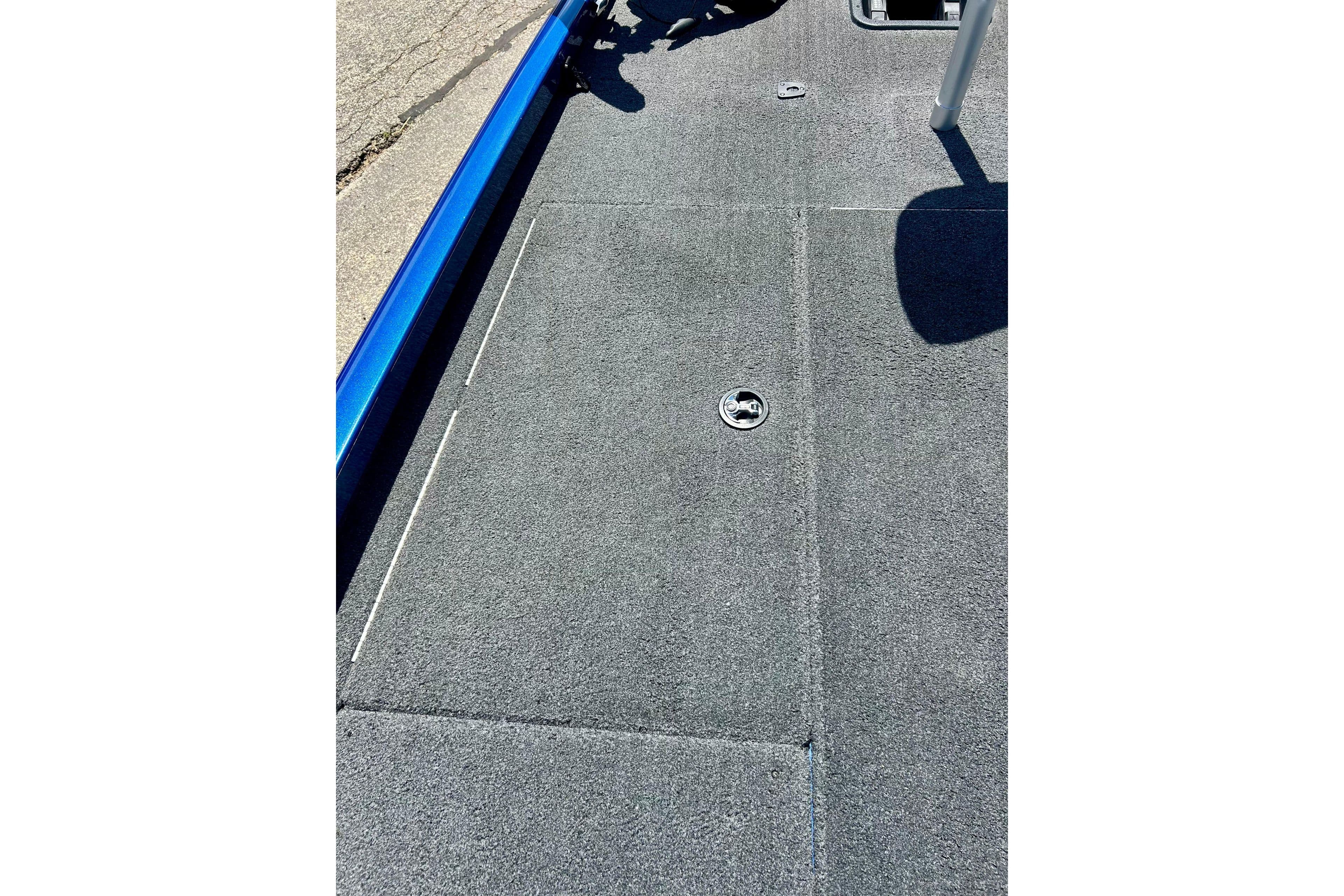 2017 Triton 18 C TX boat deck with gray carpet and storage hatch.