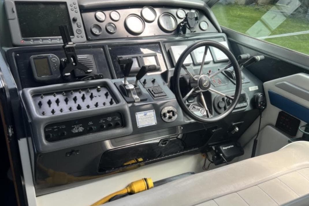 1991 Sea Ray 400 Express Cruiser helm with steering wheel and control panel.