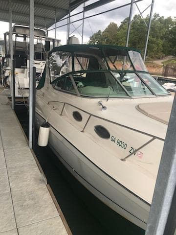 1997 Regal 292 Commodore boat docked in a marina.