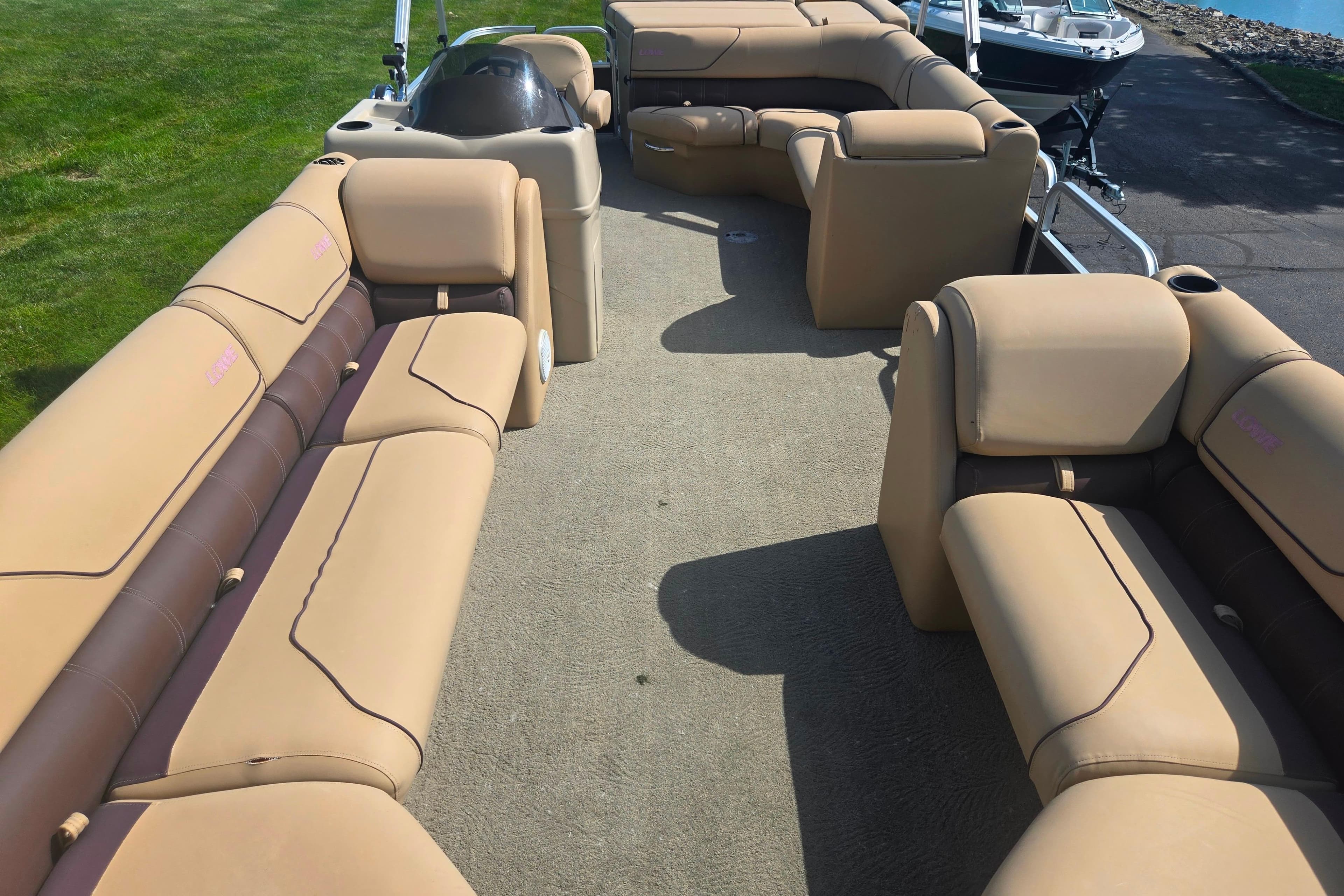 2017 Lowe SS 250 pontoon boat with tan seating and spacious deck layout.
