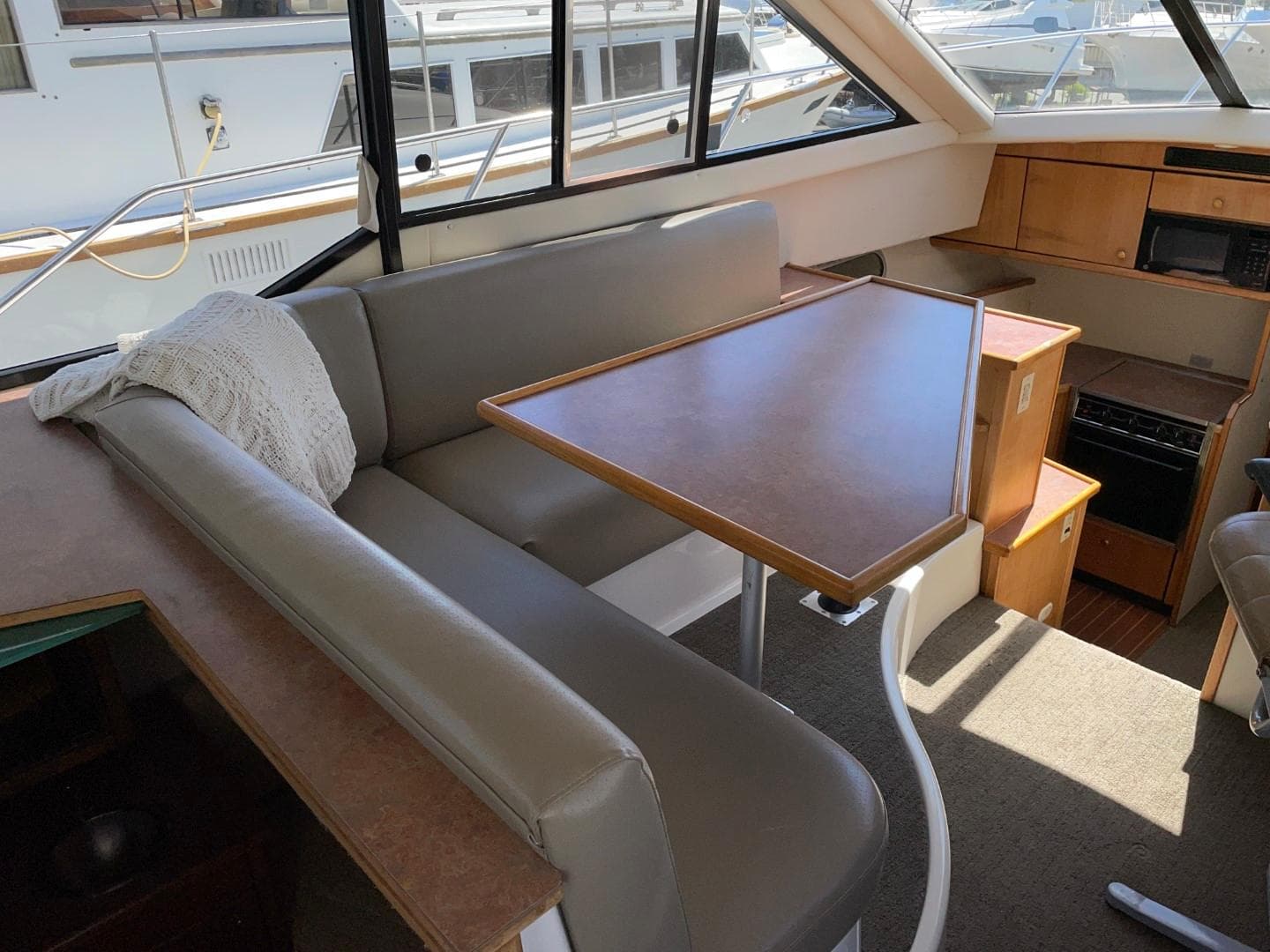 Interior of a 1999 Bayliner 3388 Motoryacht with dining area and kitchen.