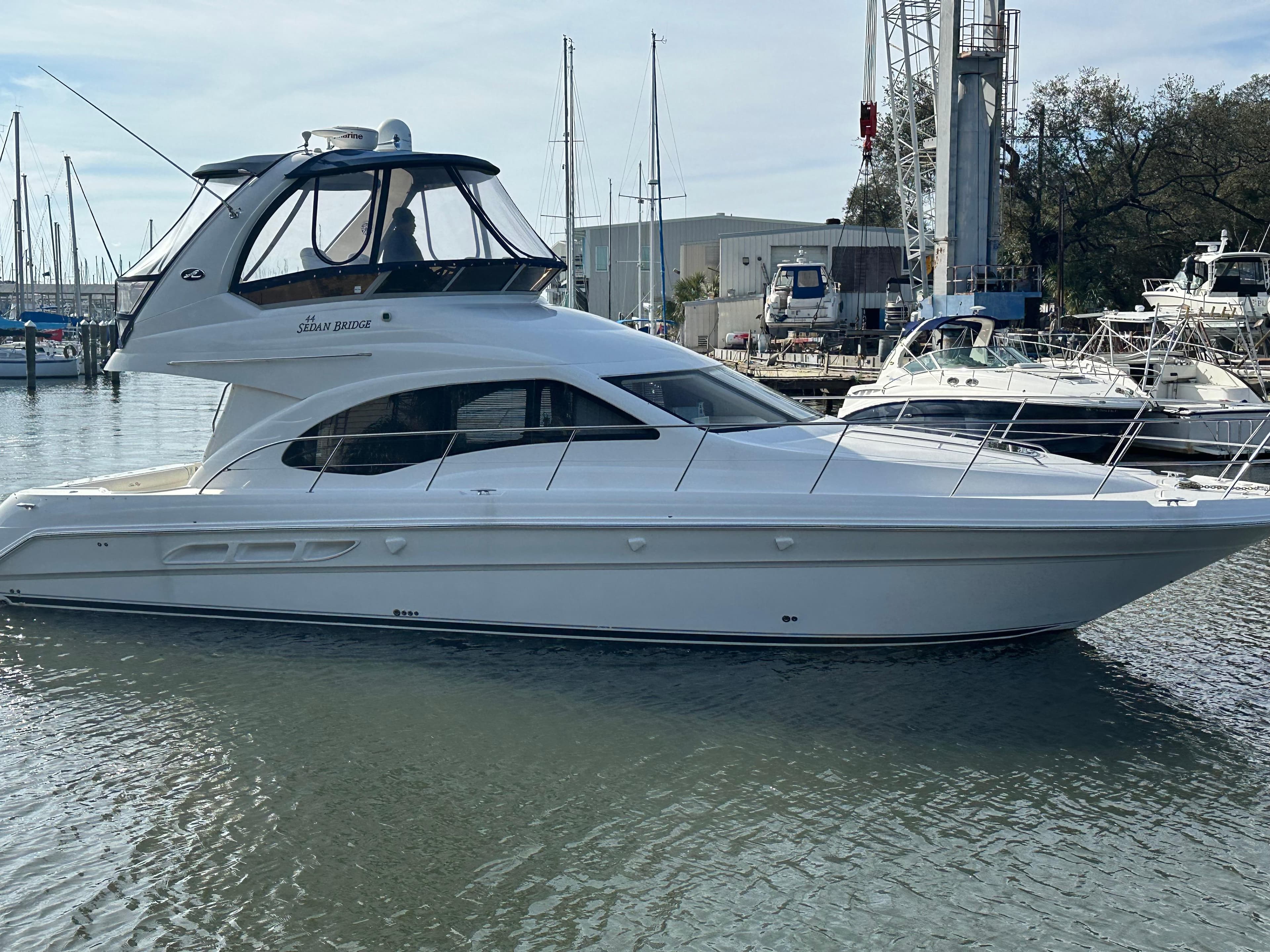 2007 Sea Ray 44 Sedan Bridge yacht docked in marina.