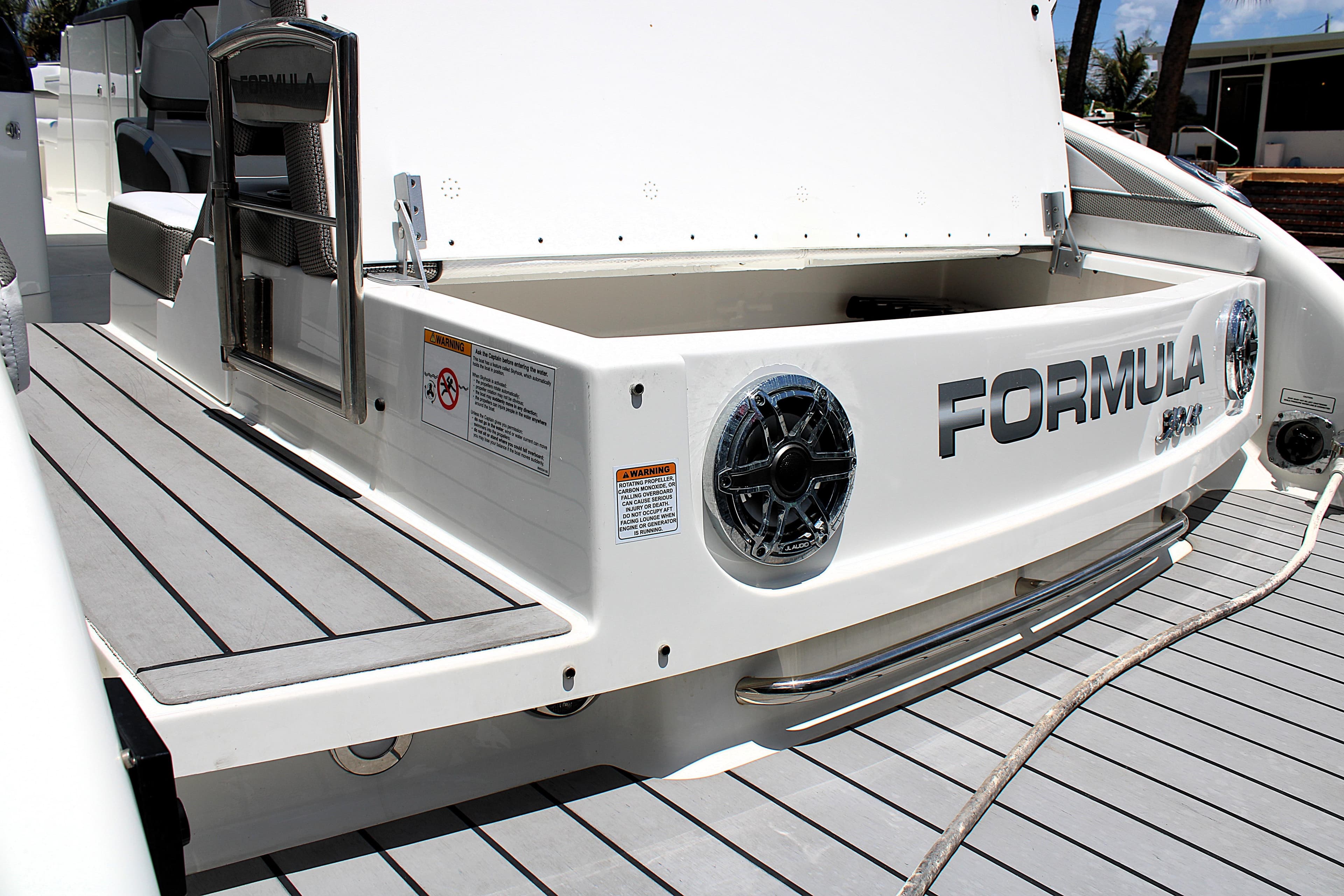 2022 Formula 310 Bowrider OB boat with sleek deck and branded rear view.