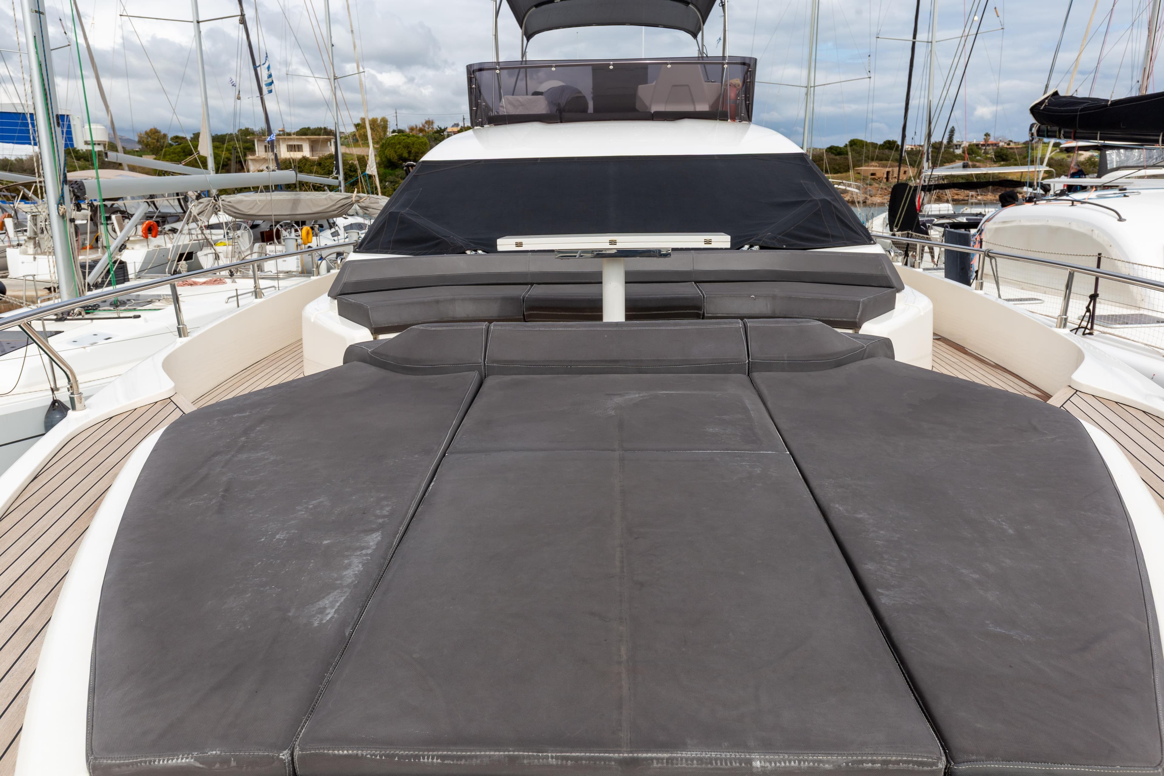 Luxurious 2022 Ferretti Yachts 550 with spacious sunbathing deck in marina setting.
