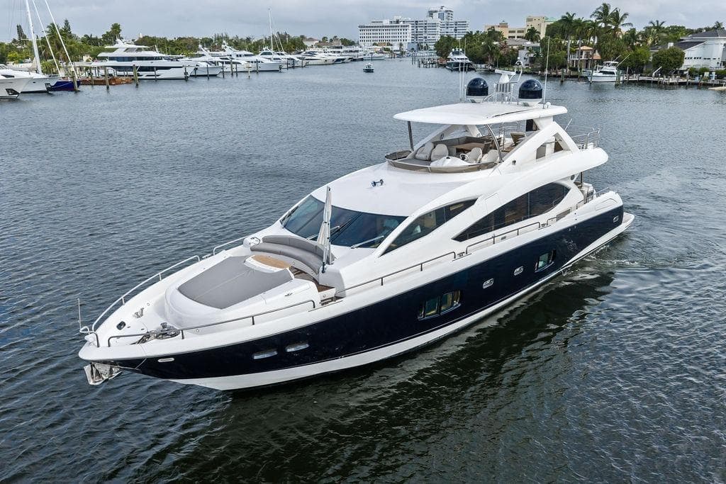 Luxurious 2012 Sunseeker 88 Yacht cruising on a serene waterway.