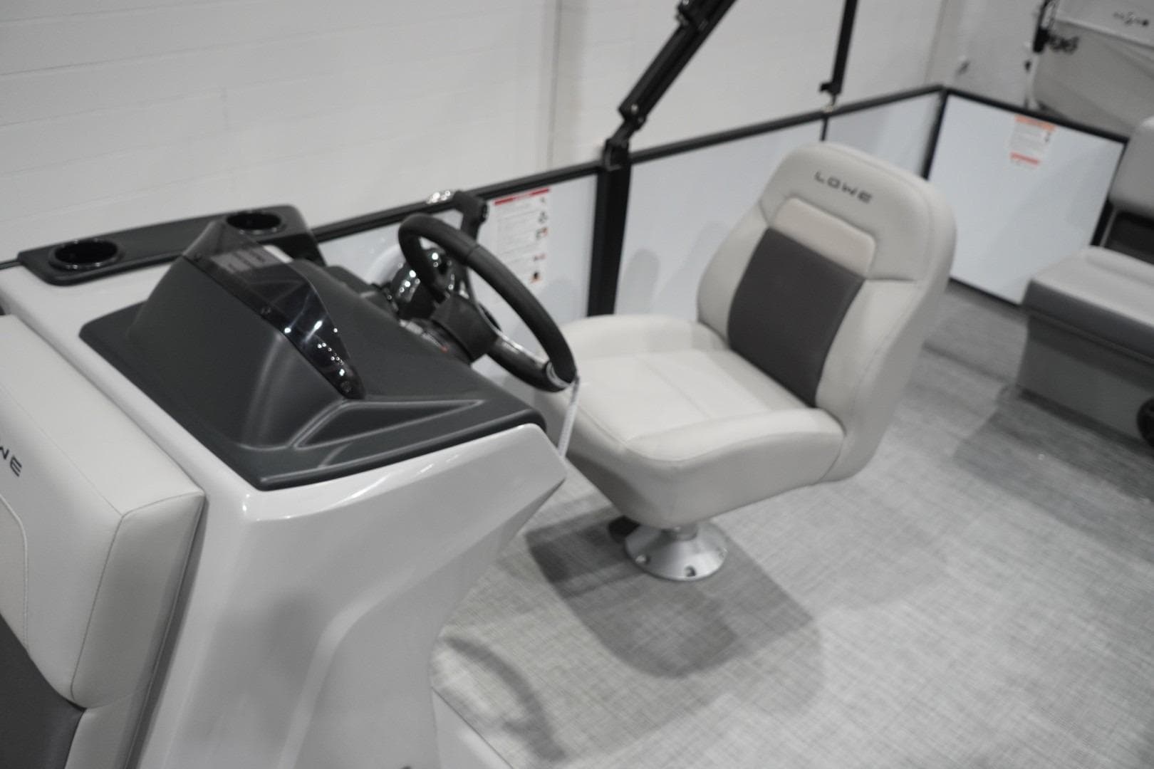 Interior of 2026 Lowe LS 190 boat featuring steering console and comfortable seating.