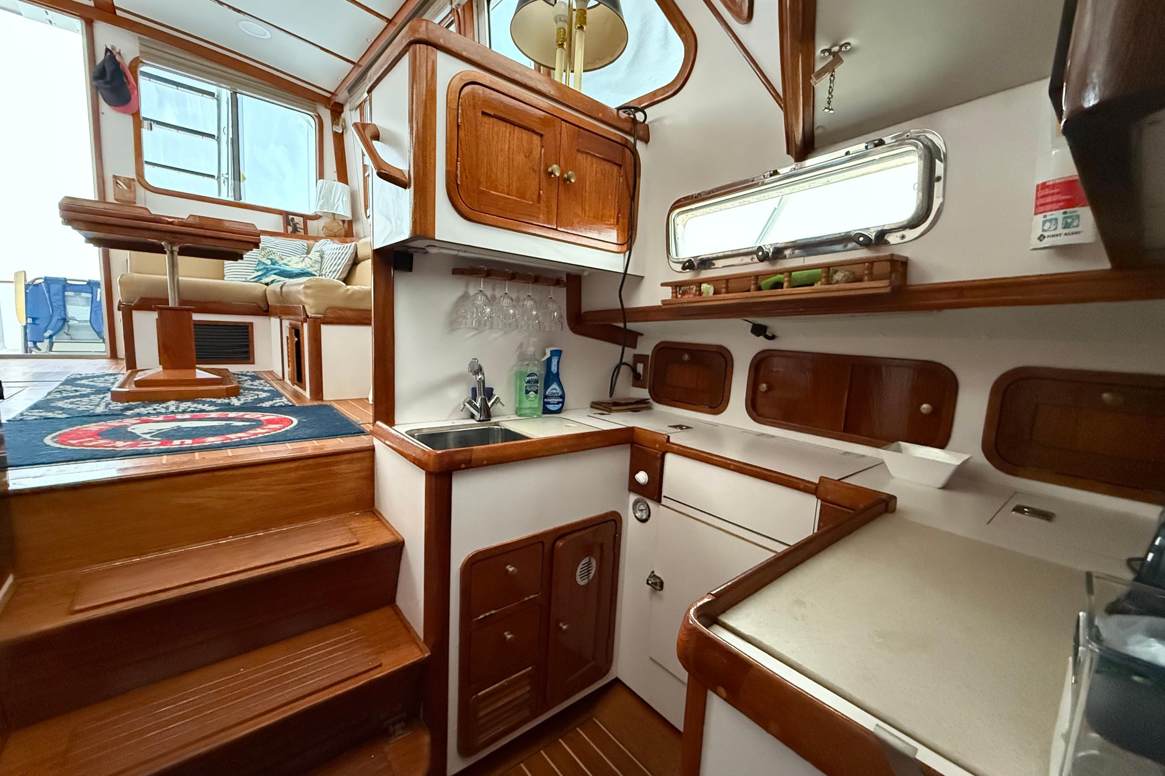 Interior of 1996 Legacy Yachts 40, featuring a cozy kitchen and seating area.