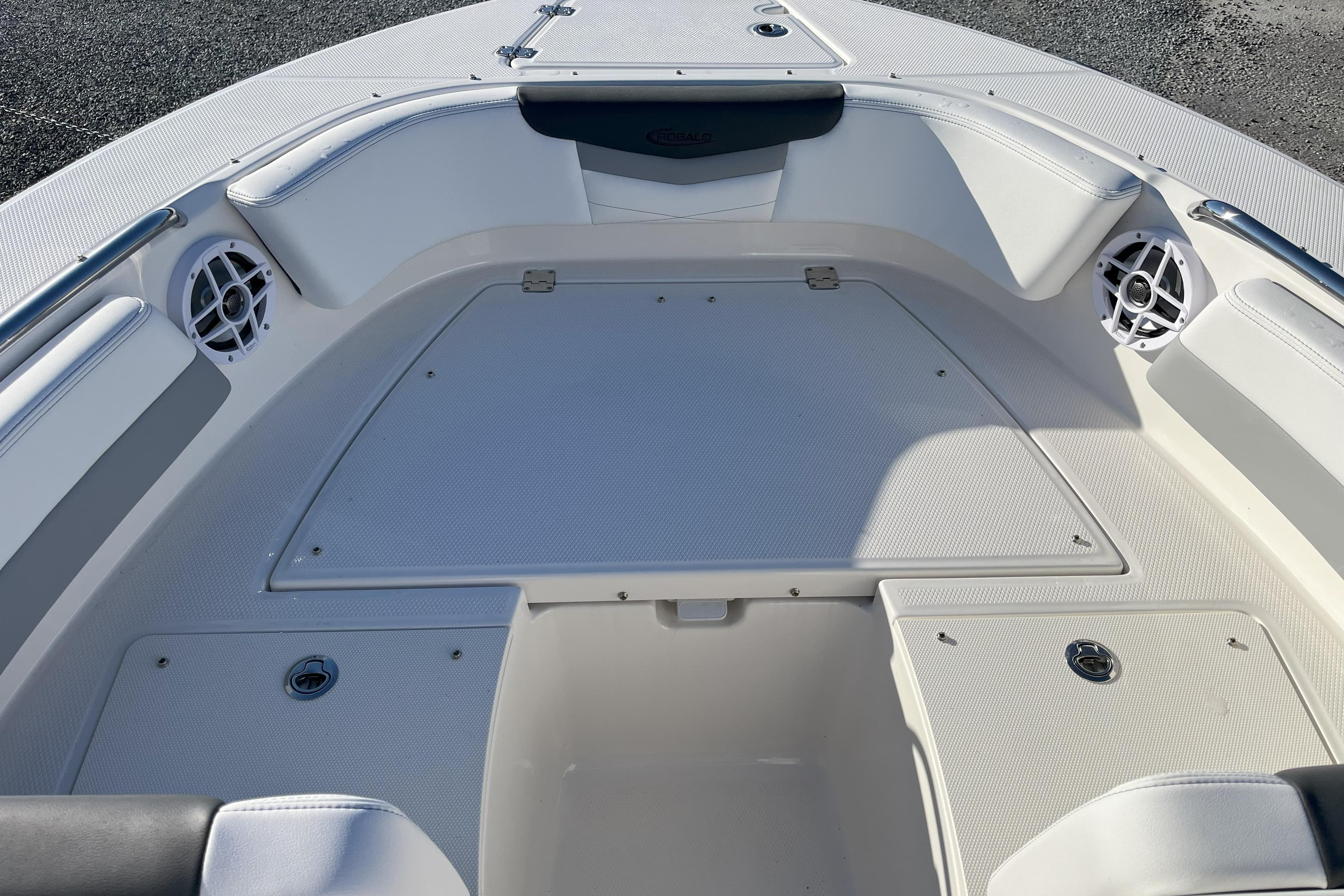 2026 Robalo R207 Dual Console boat interior with white seating and storage compartments.