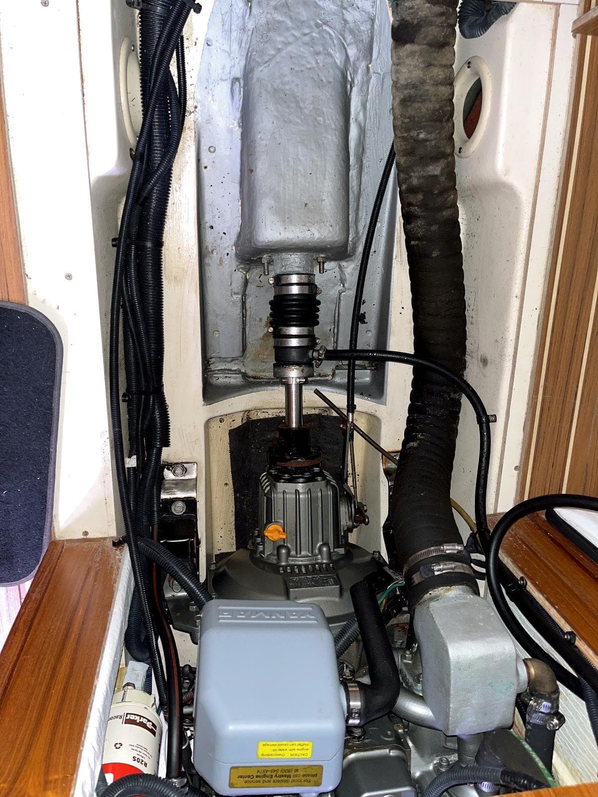 Engine compartment of a 2005 Hunter 38 sailboat, showing mechanical components and wiring.