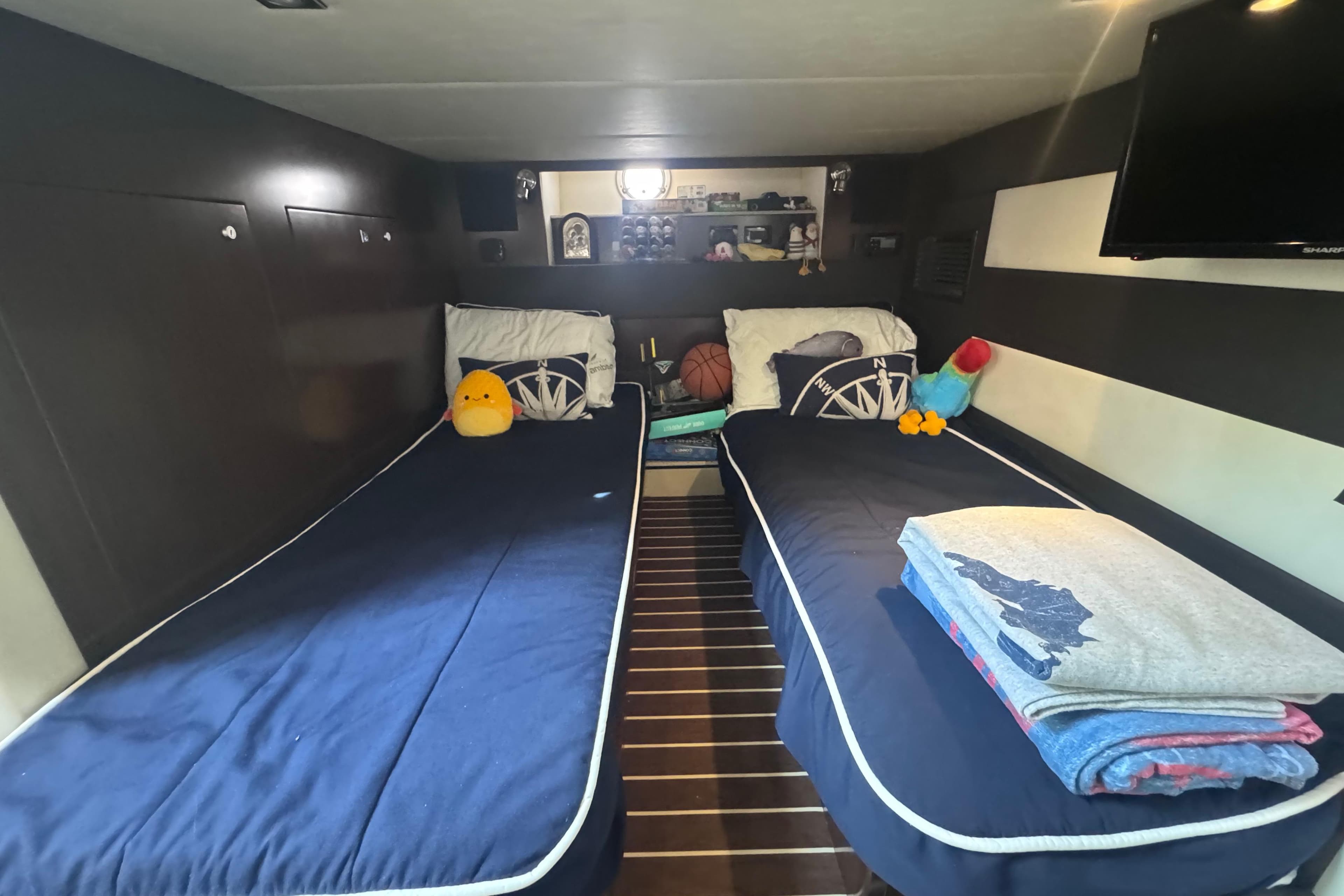 Interior of 2012 Cruisers Yachts 41 Cantius with twin beds and plush toys.