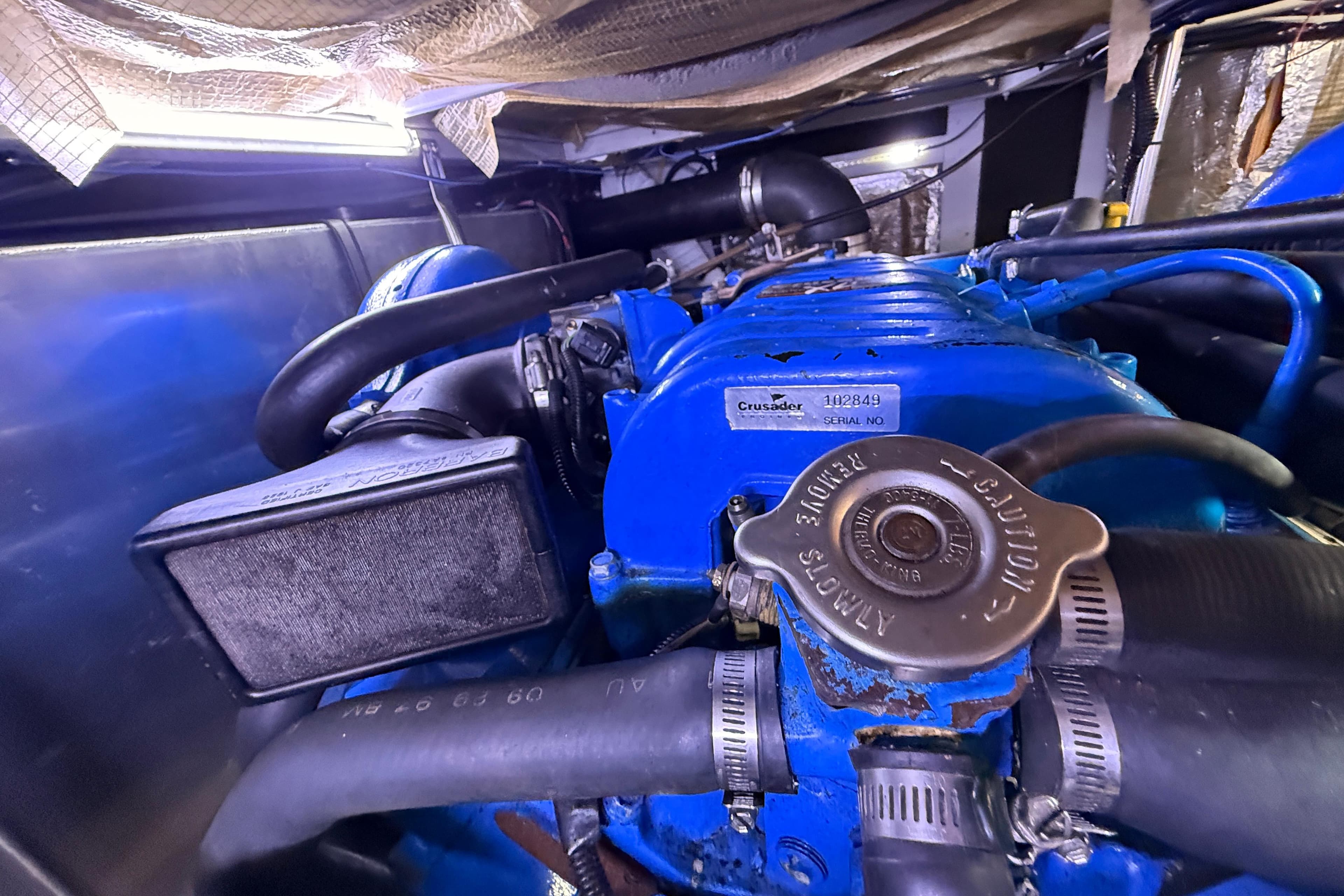 Engine compartment of a 1998 Silverton 40 Convertible boat, featuring a Crusader engine.