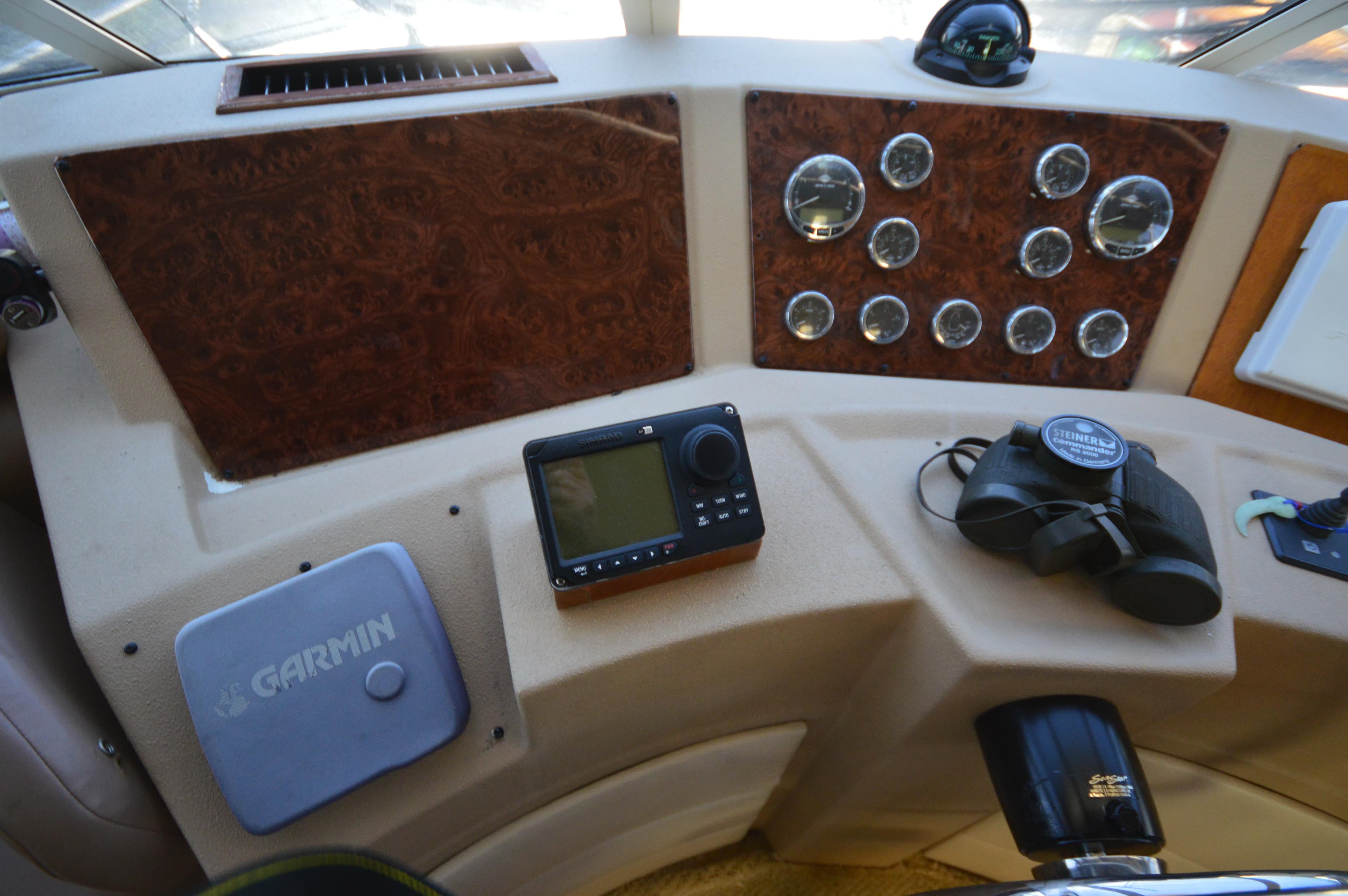Dashboard of a 2007 Meridian 490 Pilothouse with navigation instruments and binoculars.