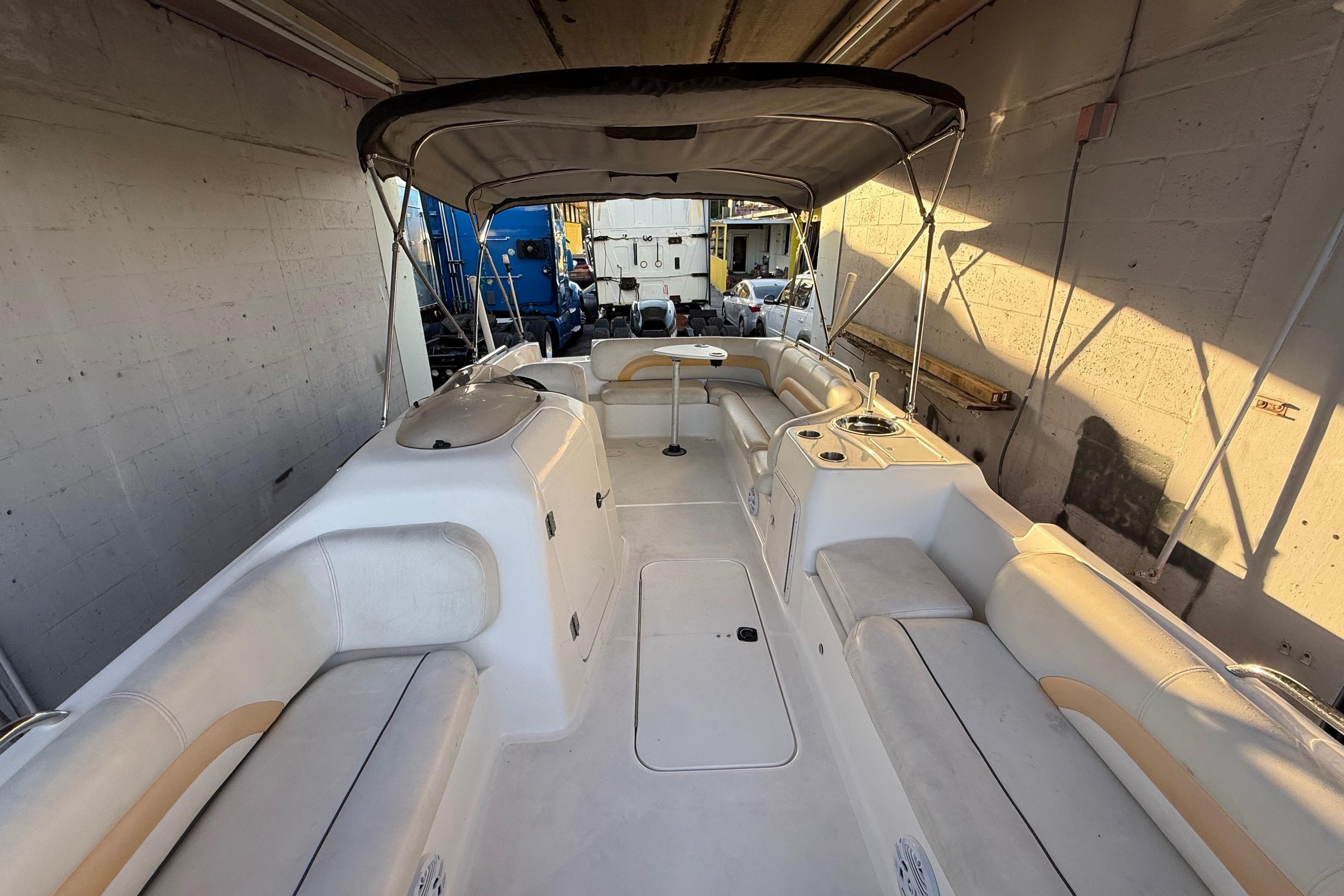 2016 Hurricane SunDeck Sport 232 OB boat interior with seating and canopy.