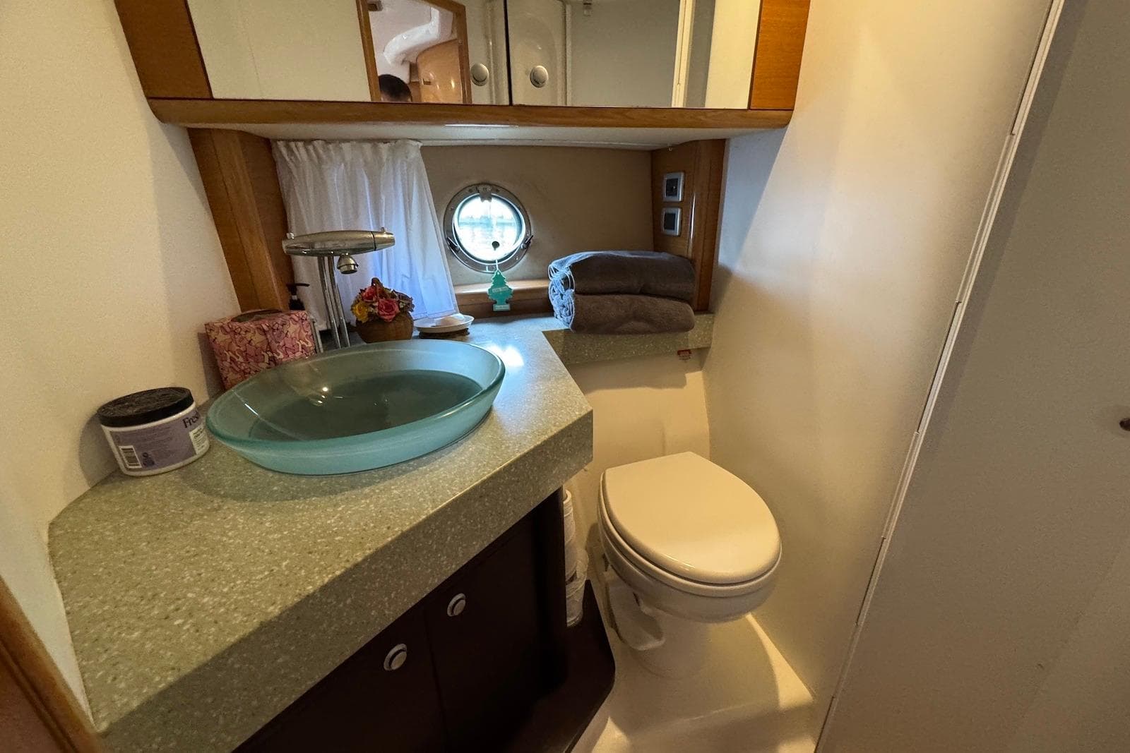 Luxurious bathroom in 2009 Cranchi Mediterranee 43 yacht with modern fixtures and porthole window.