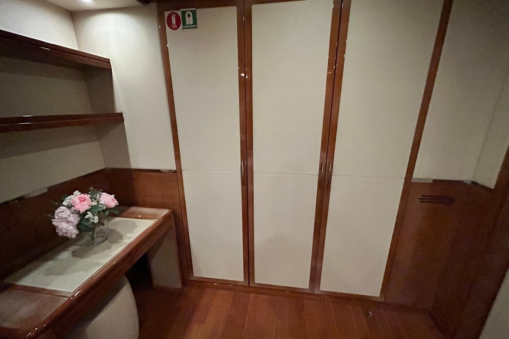 Luxurious interior of 2010 Versilcraft Euroyacht Planet 125S, featuring elegant wood finishes and floral decor.