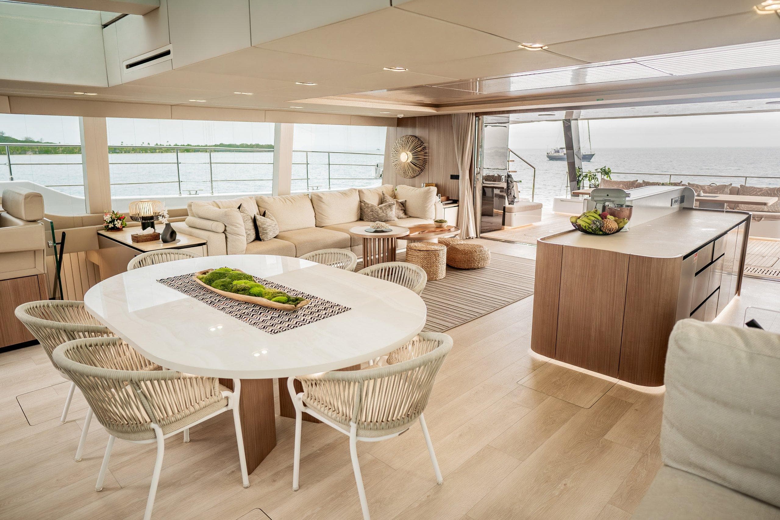 Luxurious interior of 2021 Sunreef Power 80 yacht with elegant dining and lounge areas.