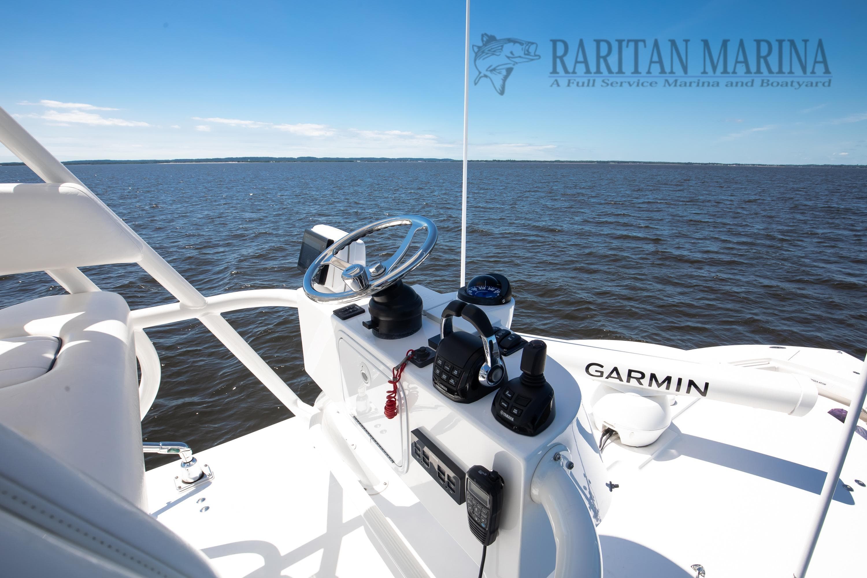 2016 Regulator 41 boat helm with Garmin equipment, overlooking calm waters.