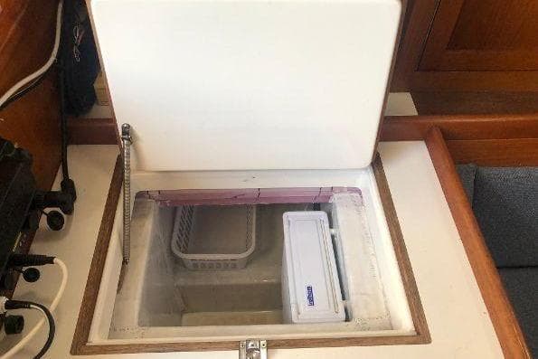 1982 Tartan 33 yacht interior with open storage compartment.
