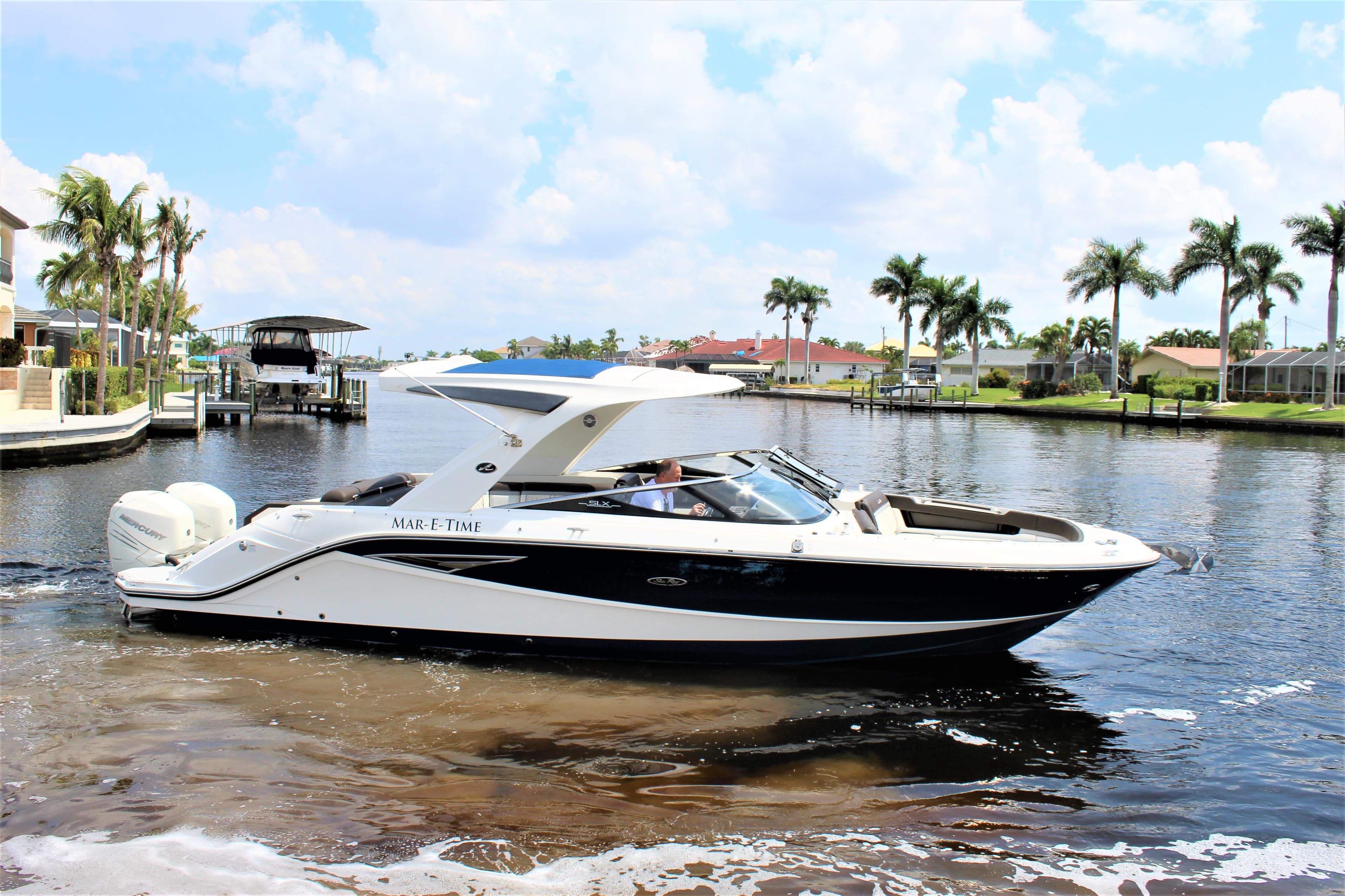 2017 Sea Ray SLX 310 boat on a sunny waterway.