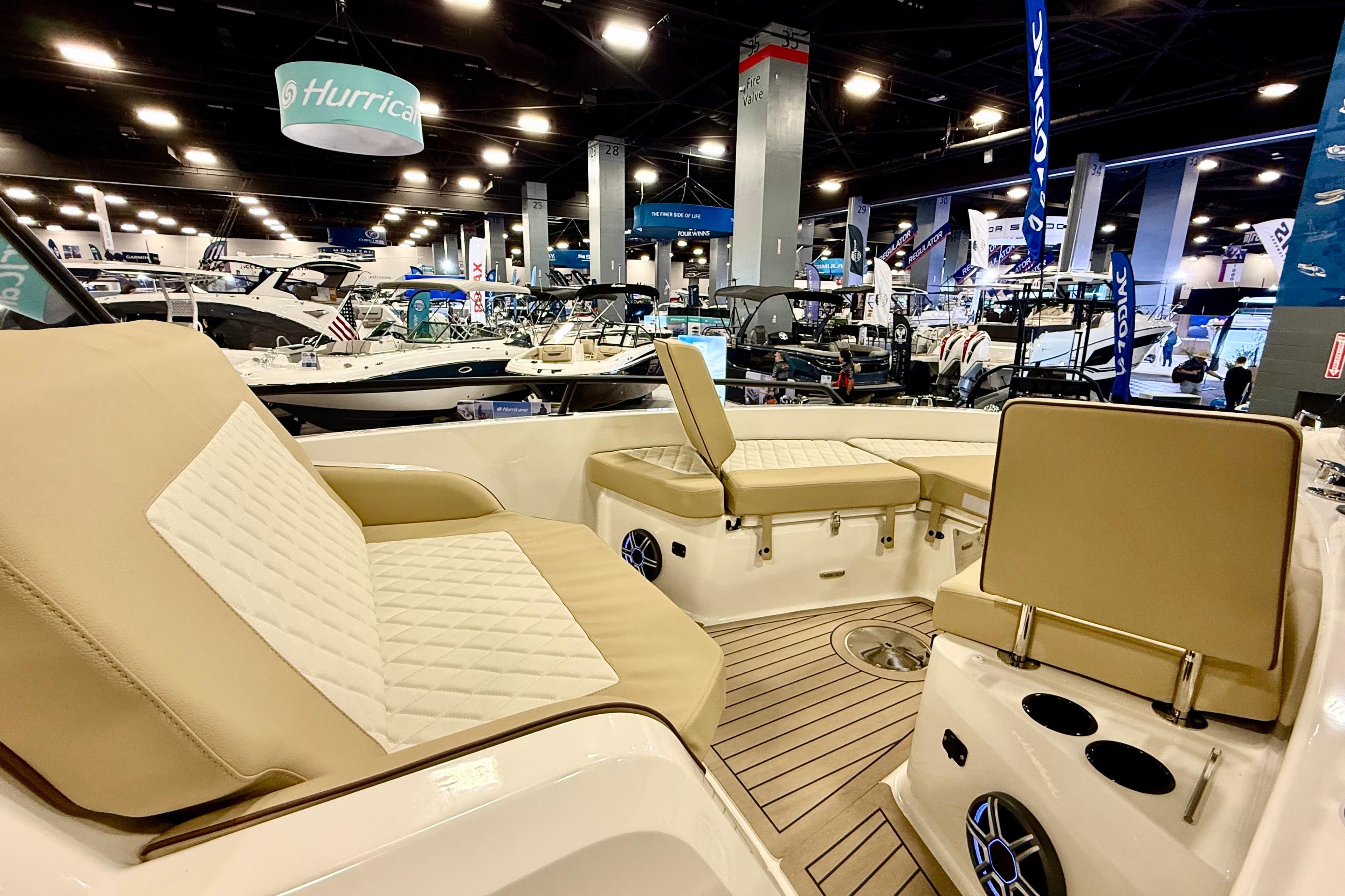 2026 Zodiac X9CC boat interior at a boat show, featuring beige seating and modern design.