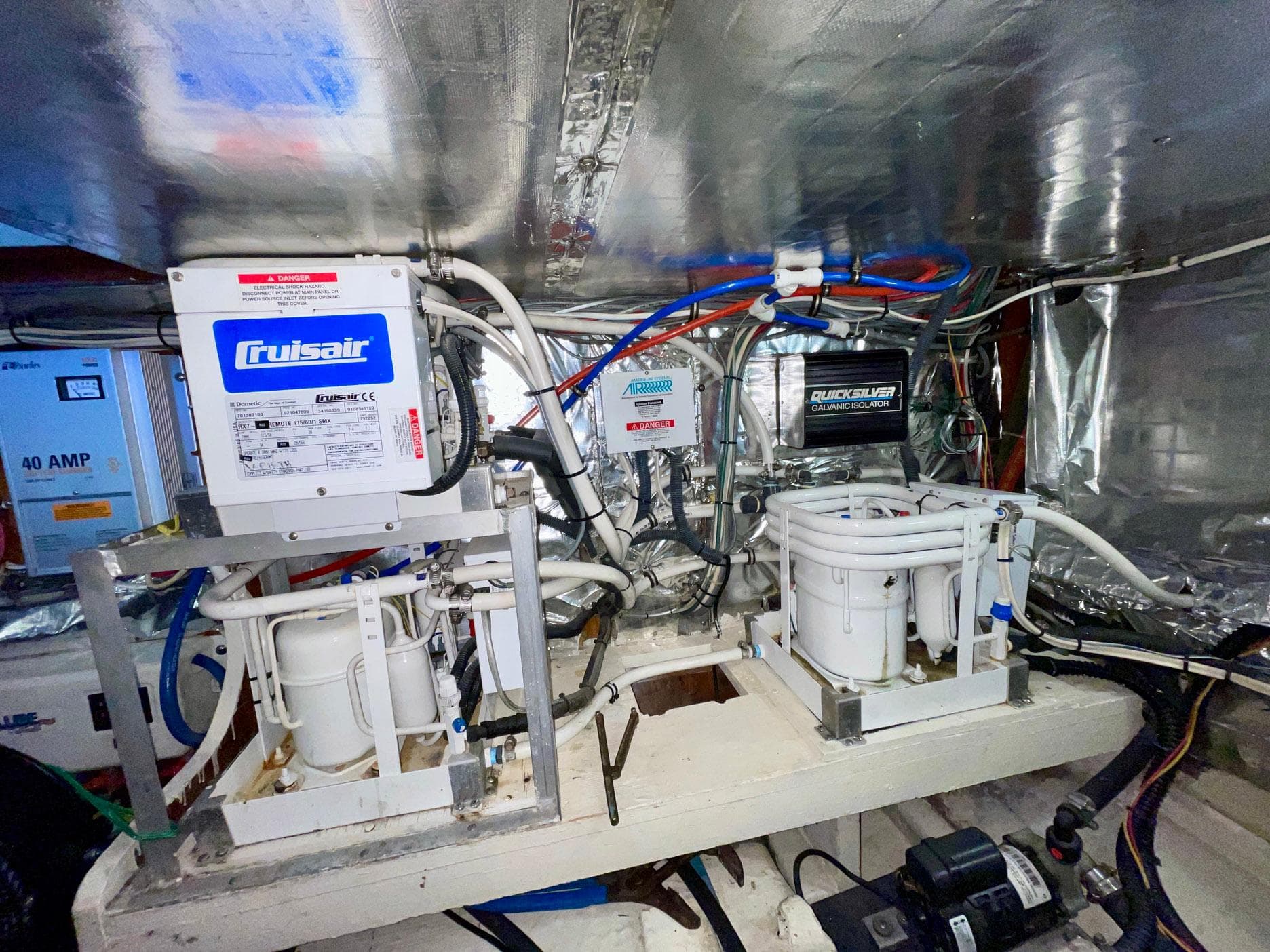 Engine room of 1988 Bertram 43 Convertible with Cruisair systems and wiring.