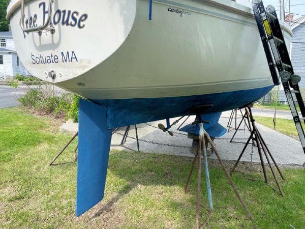 1988 Catalina 30 MkII sailboat on stands, Scituate MA, with blue hull and rudder.