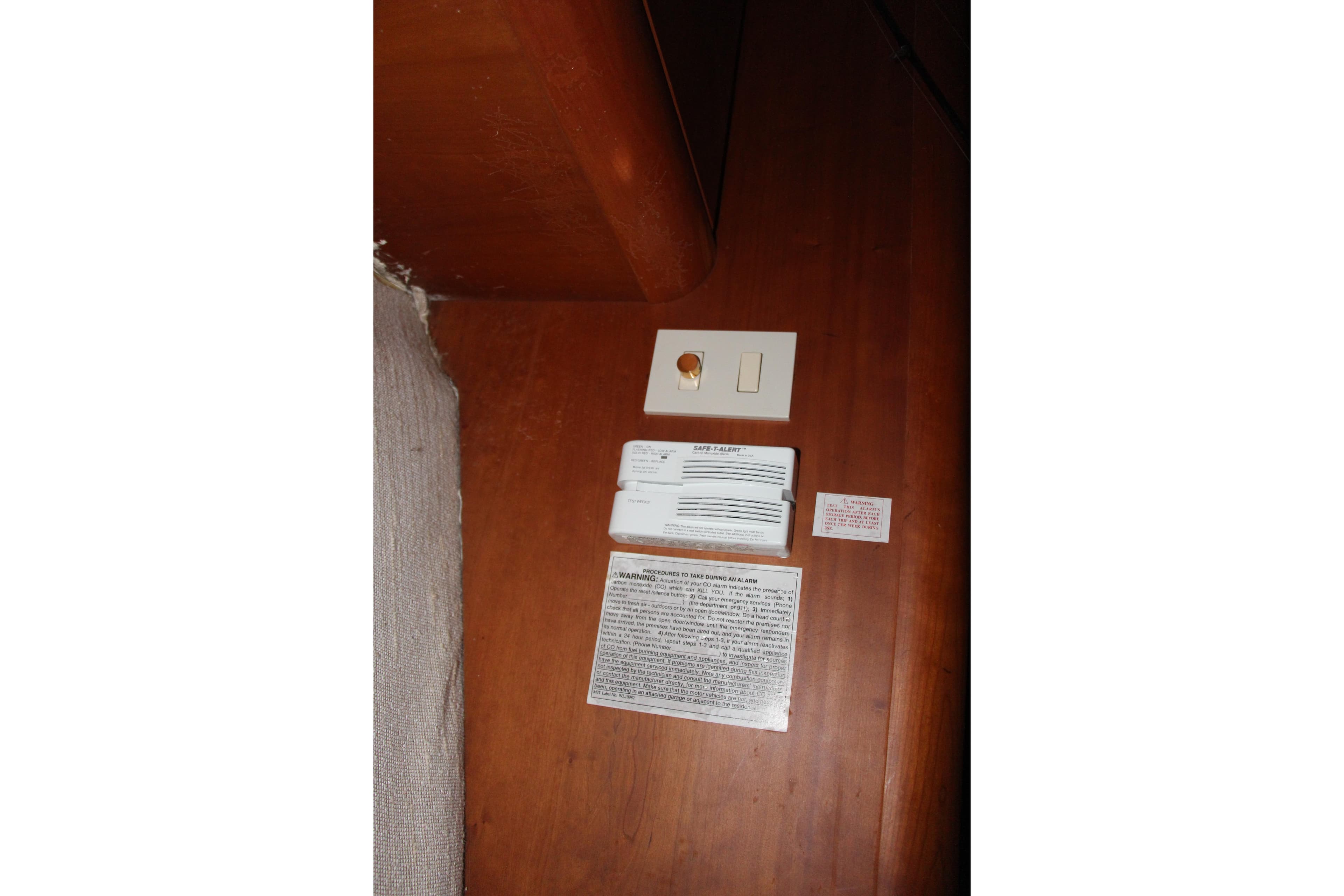 2003 Silverton 38 Convertible interior with safety instructions and control panel on wooden surface.