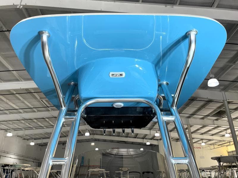 2025 Key West 210 Bay Reef boat with blue T-top and stainless steel frame.