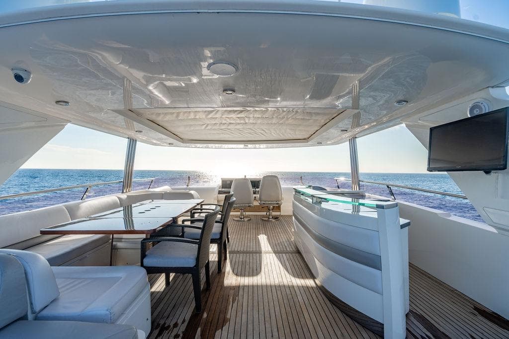 Luxurious 2010 Princess 95 Motor Yacht deck with seating, table, and ocean view.