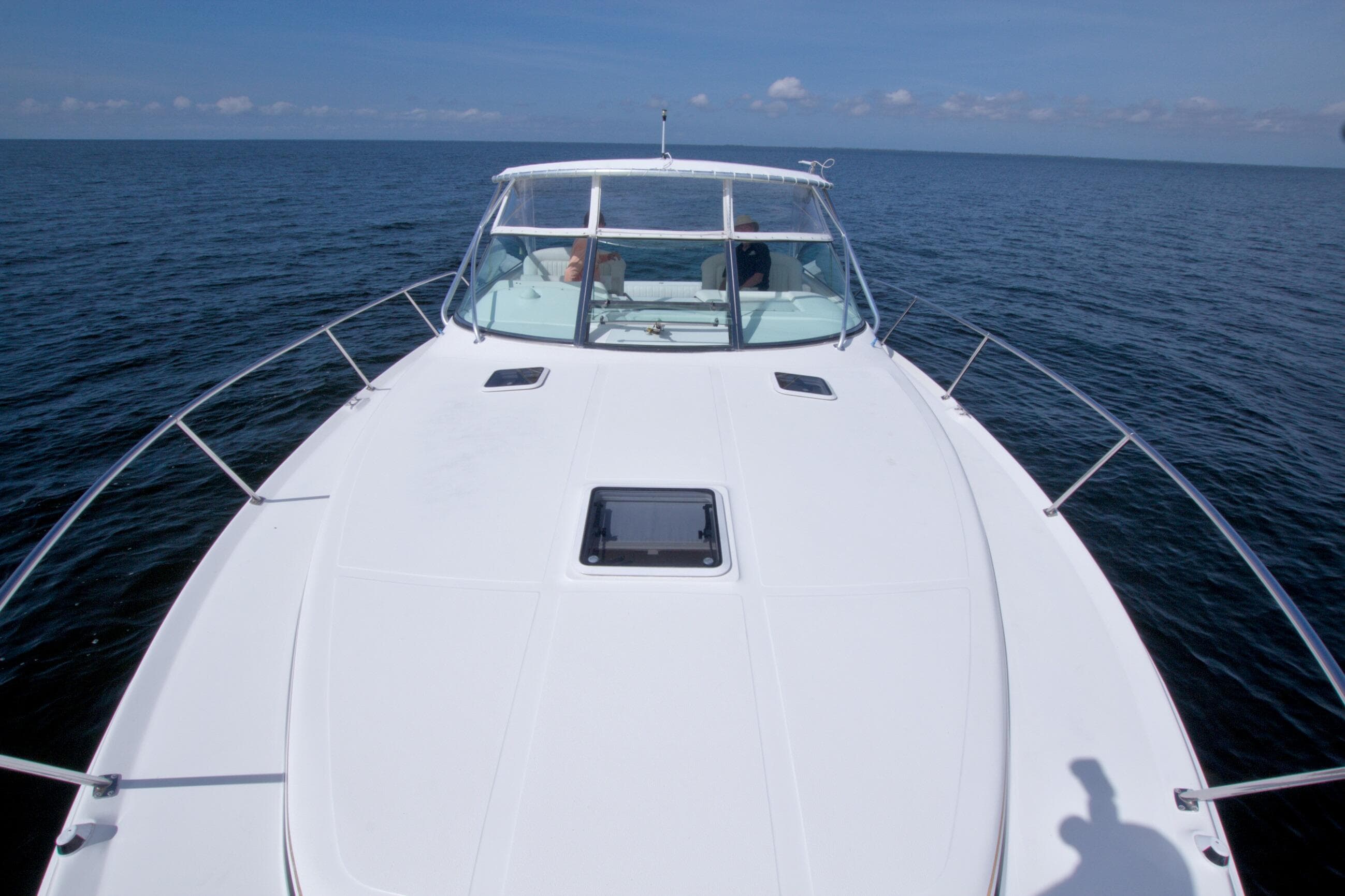 1997 Sea Ray 370 Express Cruiser on open water, showcasing sleek deck design.