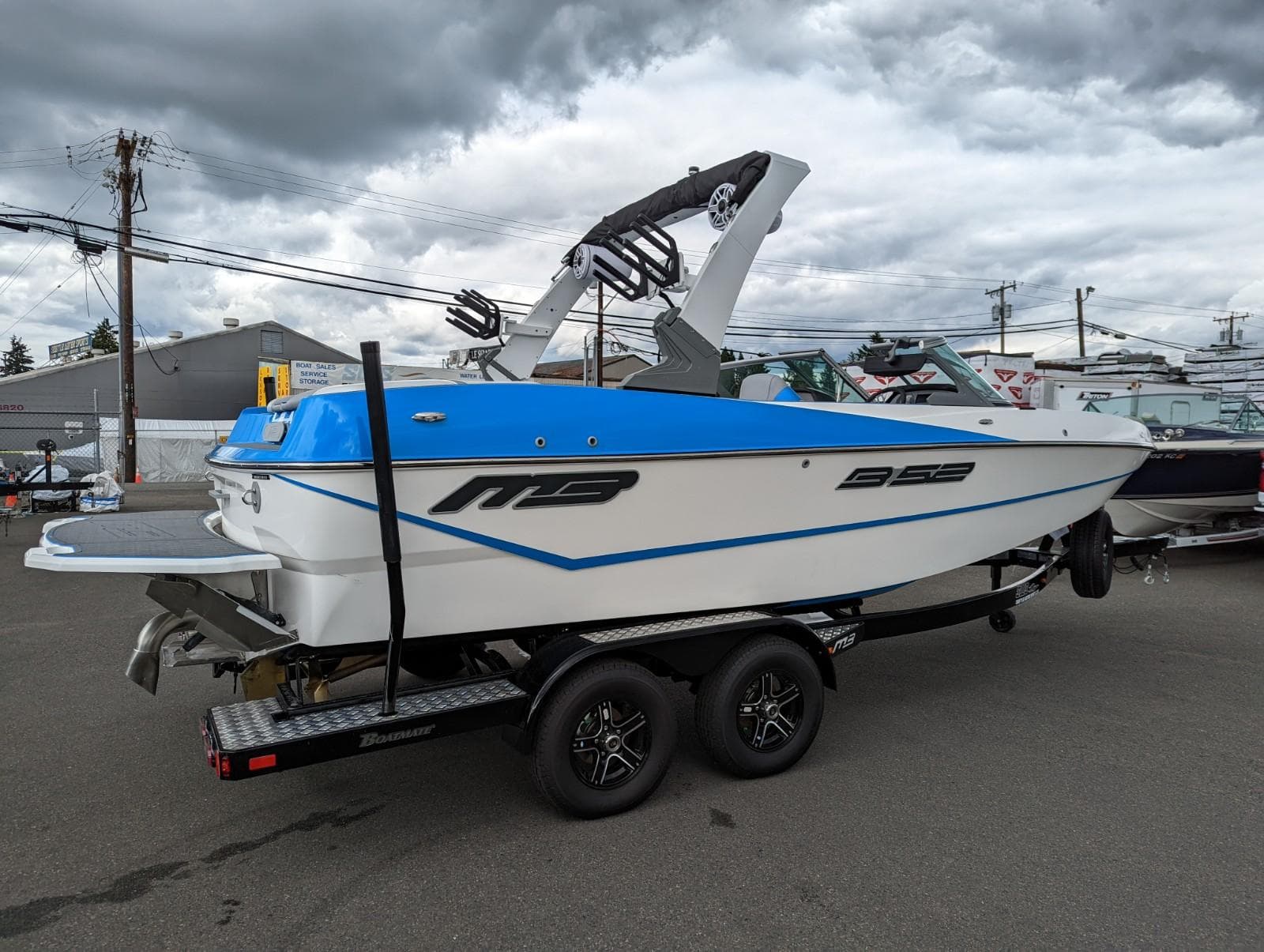2022 MB B52-21 Classic boat on trailer, blue and white, side view.