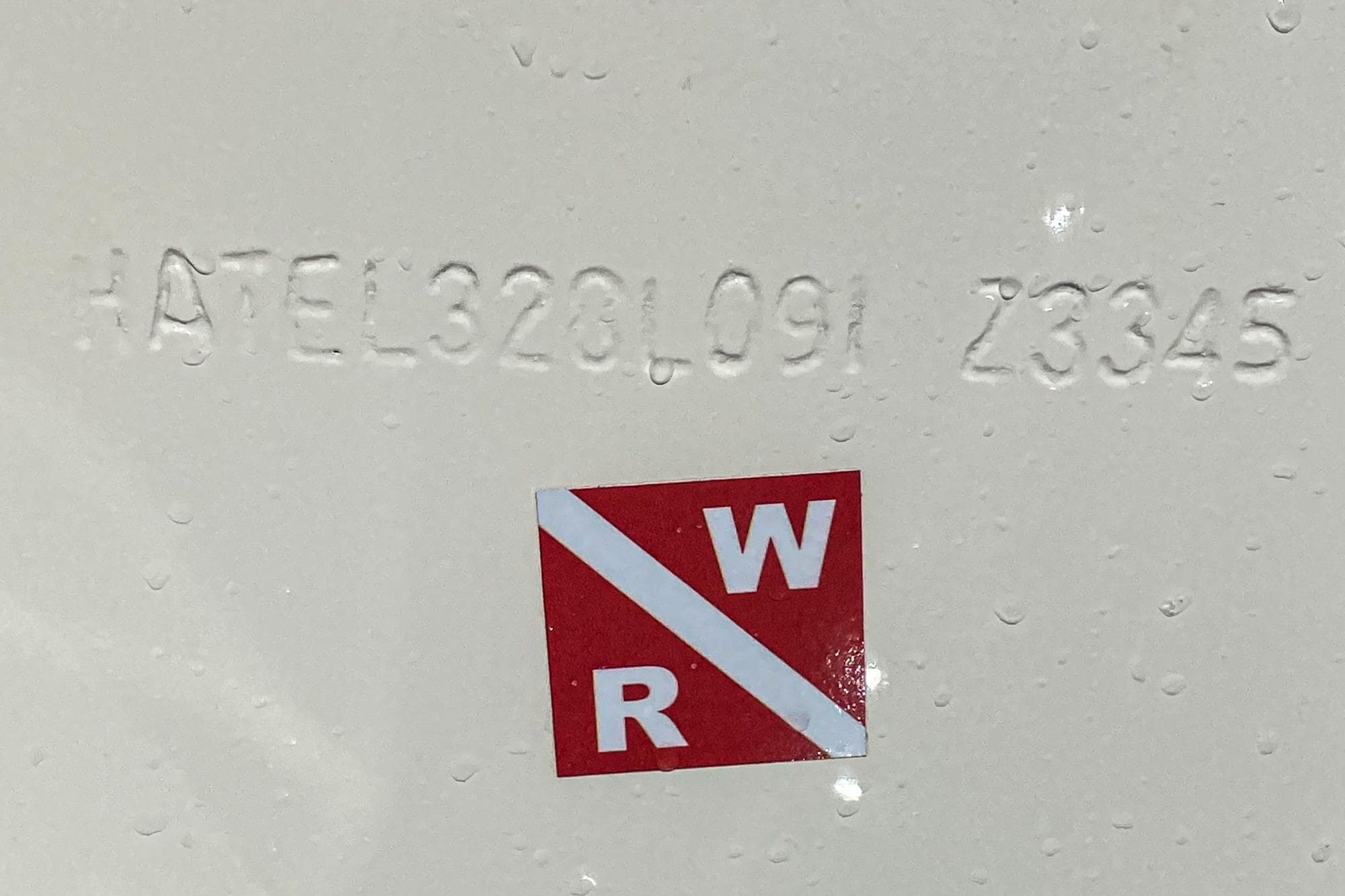Hull identification number on 1991 Hatteras 58 Convertible with red and white sticker.