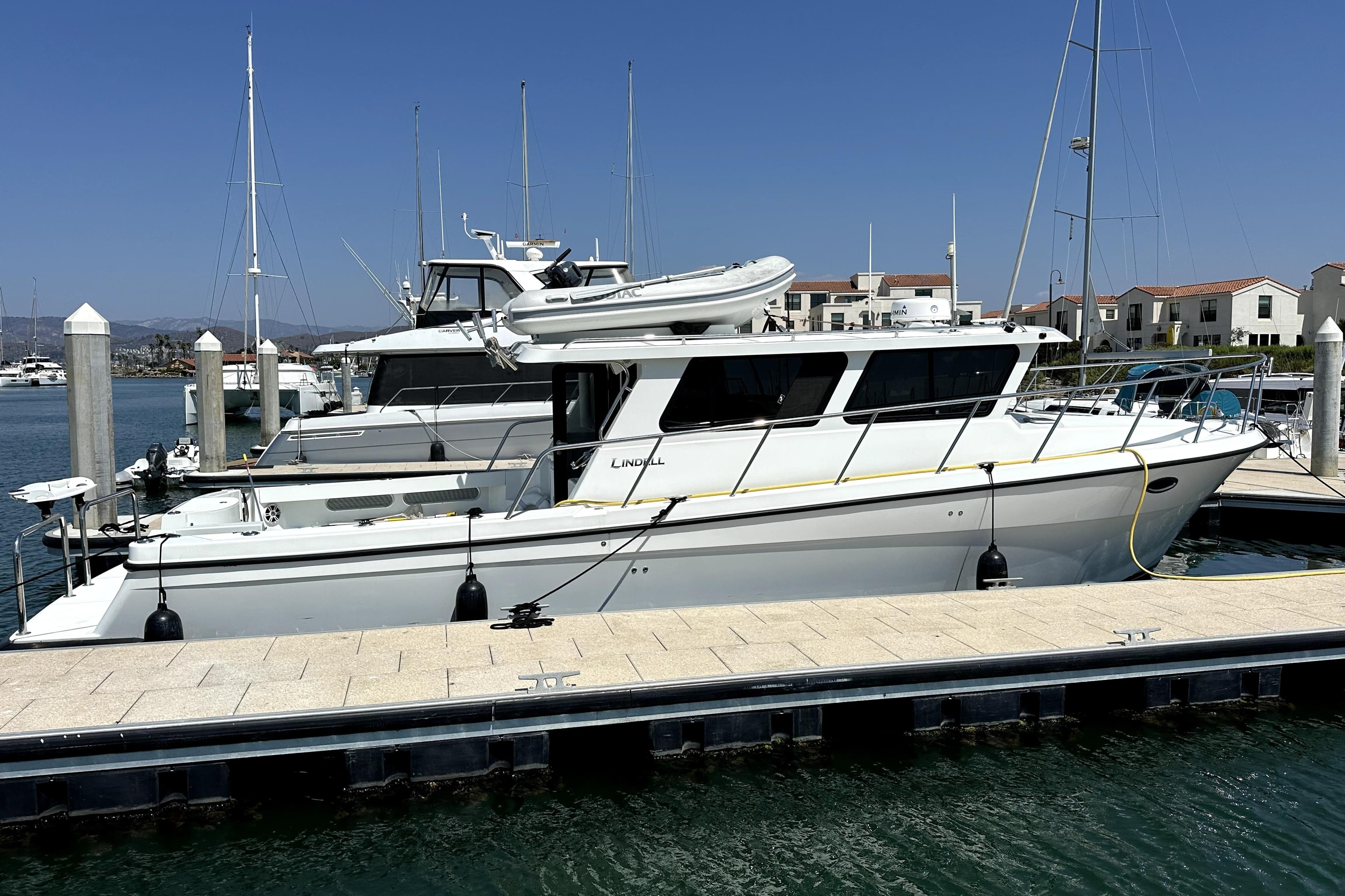 2021 Lindell 42/46 yacht docked at marina under clear blue sky.