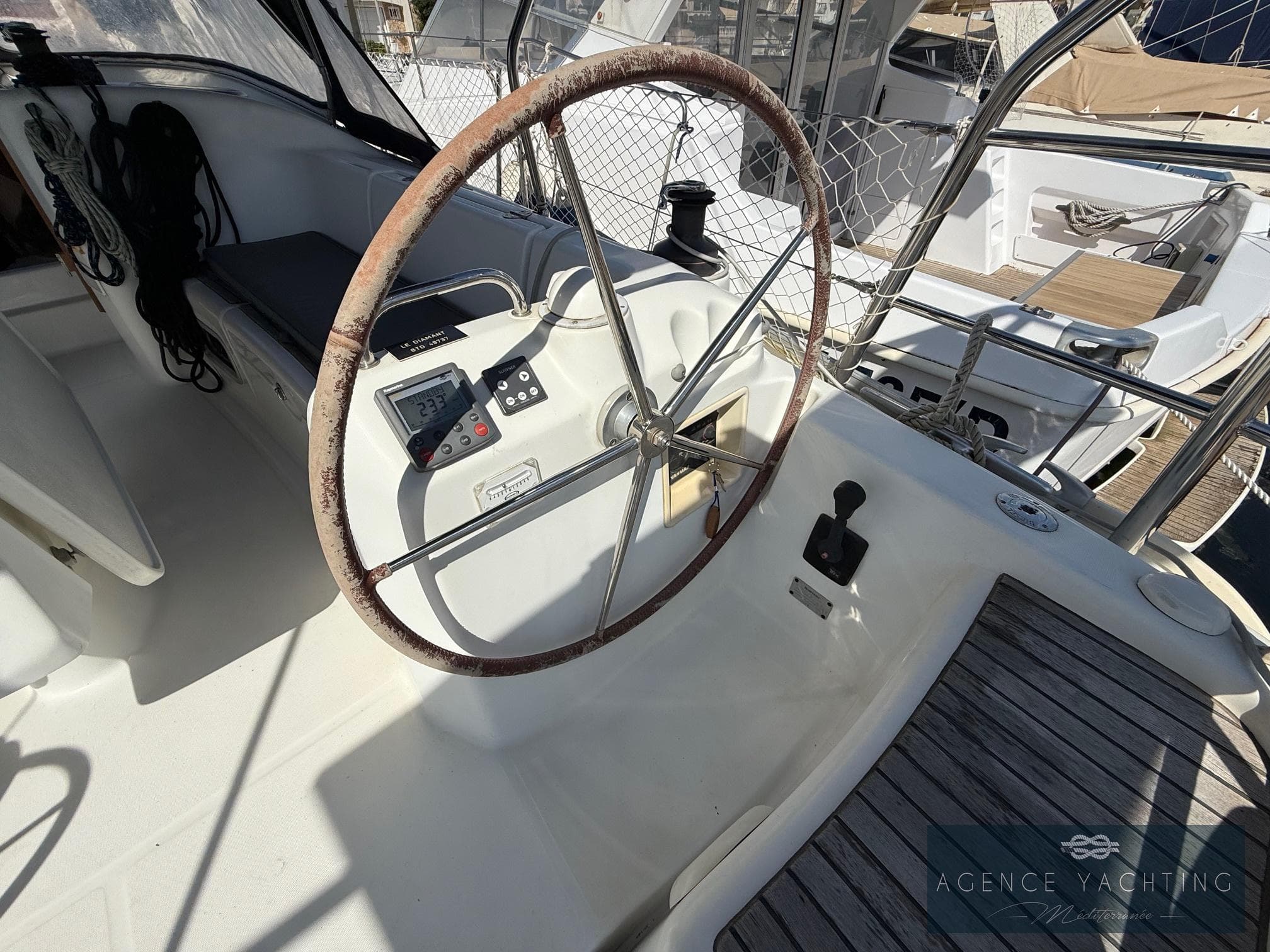 2007 Beneteau Cyclades 39 yacht cockpit with steering wheel and navigation controls.