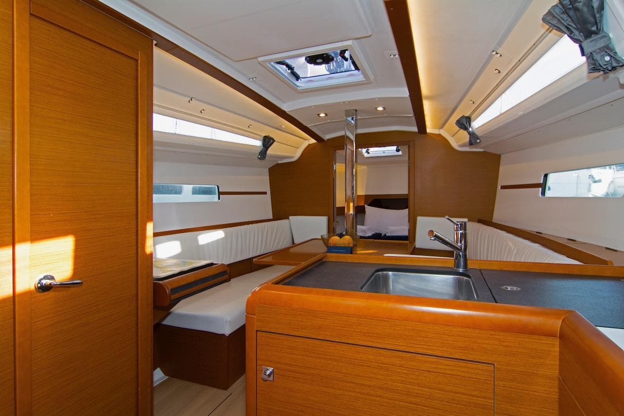 Interior of 2017 Jeanneau Sun Odyssey 349 sailboat with modern wood finish and seating area.